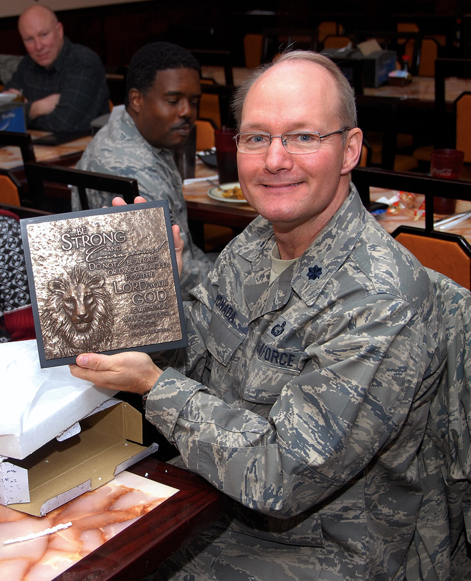 Lt. Col. Troy Vonada displays a gift received during his recent farewell lunch. The recent colonel selectee is leaving the 908th for the 22nd Air Force. (Photo by Gene H. Hughes)