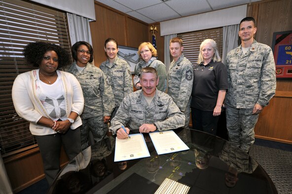 ALTUS AIR FORCE BASE, Okla. – U.S. Air Force Col. Bill Spangenthal, 97th Air Mobility Wing commander, signs a proclamation March 26, 2014. The proclamation officially designates April as Sexual Assault Awareness Month here at Altus AFB. For more information about sexual assault prevention or the list of events, contact the sexual assault prevention and response office at 580-481-7428. (U.S. Air Force photo by Senior Airman Dillon Davis/Released)