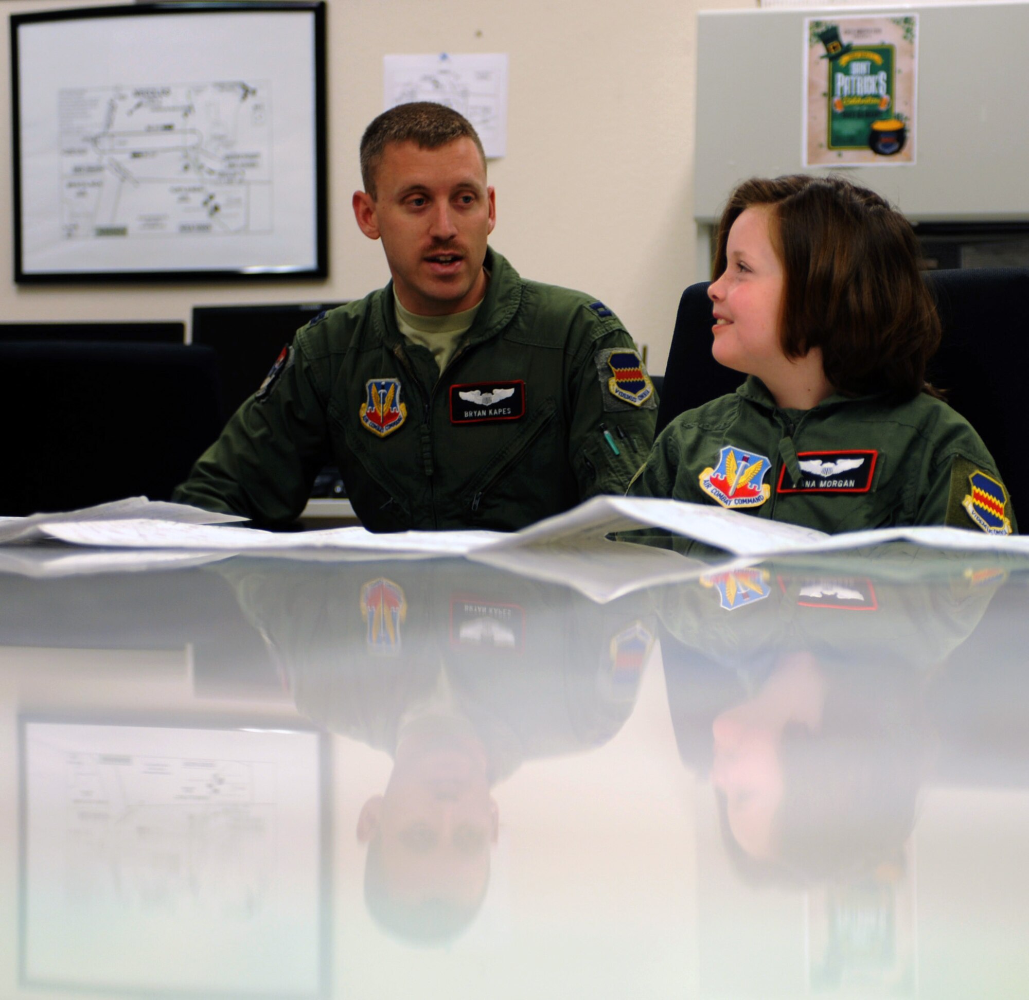 U.S. Air Force Capt. Bryan Kapes, 43rd Electronic Combat Squadron, briefs Dana Morgan, honorary 43rd ECS Pilot for a Day, about pre-flight information at Davis-Monthan Air Force Base, Ariz., March 14, 2014. Morgan and her family were escorted by Kapes, whose unit hosted the Pilot for a Day tour.  (U.S. Air Force Photo by Airman 1st Class Chris Massey/Released)