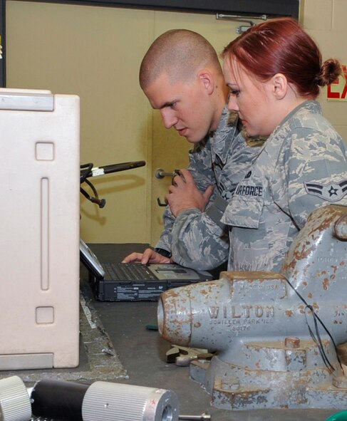 Senior Airman Johnathan Martin and Airman 1st Class Kristen Tanner, 2nd Maintenance Squadron Electrical and Environmental systems journeymen, review a technical order prior to a final inspection on a liquid oxygen tank, or LOX tank, on Barksdale Air Force Base, La., March 24, 2014. After the repair, the LOX tank may be used to provide breathable air on a B-52H Stratofortress that same day.  (U.S. Air Force photo/Airman 1st Class Benjamin Raughton)