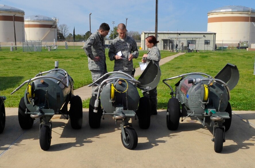 Senior Airman Corey Richer, 707th MXS Electric and Environmental systems journeyman, and Senior Airman Johnathan Martin and Airman 1st Class Kristen Tanner, 2nd Maintenance Squadron E and E systems journeymen, review a sheet detailing issues with the liquid oxygen tanks on Barksdale Air Force Base, March 24, 2014. The tanks need regular maintenance in order to provide B-52H Stratofortress pilots with clean, breathable air. (U.S. Air Force photo/Airman 1st Class Benjamin Raughton)