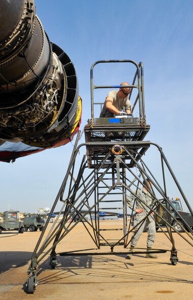 Senior Airman Johnathan Martin, 2nd Maintenance Squadron Electrical and Environmental Systems journeyman, retrieves tools prior to inspecting a B-52H Stratofortress valve on Barksdale Air Force Base, La., March 21, 2014. Martin performed a bleed-air check to ensure the valves didn’t leak air. In a phase inspection, the valves may be checked every 450 flight hours. (U.S. Air Force Photo/Airman 1st Class Benjamin Raughton)