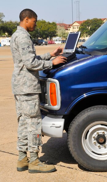 Airman 1st Class Julian Glass, 2nd Maintenance Squadron Electrical and Environmental Systems apprentice, references a technical order prior to checking a B-52H Stratofortress valve on Barksdale Air Force Base, La., March 21, 2014. Valves and ducts on the aircraft engine are checked for air leaks. A thorough inspection of the air ducts may take several hours. (U.S. Air Force Photo/Airman 1st Class Benjamin Raughton)