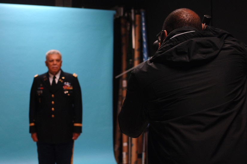 Christopher Thompson, Enterprise Multimedia Center photo systems specialist, takes a Department of the Army official photograph of retired U.S. Army Col. Terry Gordon, Bethel High School Army Junior ROTC instructor at Fort Eustis, Va., March 25, 2014. EMC’s photography department documents military events and missions, as well as DA photographs required for Soldiers’ official folders and promotion boards. (U.S. Air Force photo by Senior Airman Teresa J.C. Aber/Released)