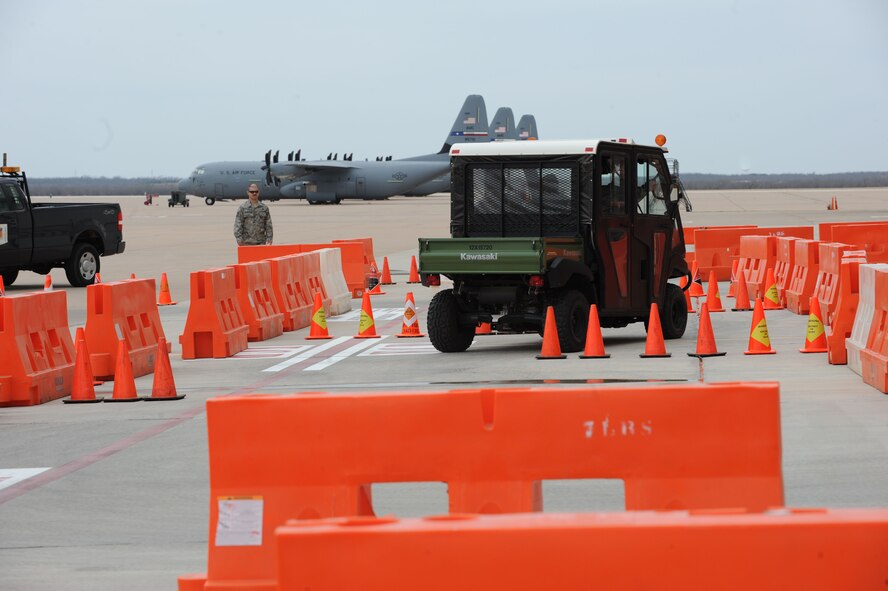 U.S. Air Force Staff Sgt. Kassondra Cline, 39th Airlift Squadron, weaves through cones, on a closed course, during the 317th Airlift Group’s quarterly Comprehensive Airman Fitness event March 21, 2014, at Dyess Air Force Base, Texas. During this demonstration, Airmen were timed on how accurately they could drive through a closed course after consuming a few alcoholic beverages. The event showed Airmen that although outwardly they might not appear intoxicated, they could potentially be impaired when it comes to hand and eye coordination and motor skills. (U.S. Air Force photo by Airman 1st Class Autumn Velez/Released)