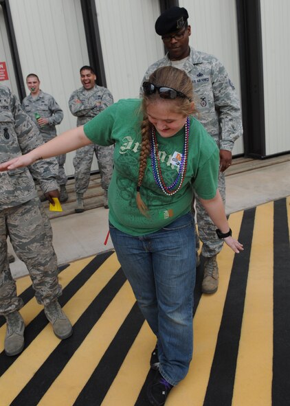 U.S. Air Force Staff Sgt. Kassondra Cline, 39th Airlift Squadron, attempts to walk a straight line during a field sobriety test given by Senior Airman Nickolas Paxton, 7th Security Forces Squadron, March 21, 2014, at Dyess Air Force Base, Texas. For the 317th Airlift Group’s Comprehensive Airman Fitness event, selected Airmen consumed a limited number of alcoholic beverages, in a controlled environment, and were then asked to demonstrate their ability to drive safely, or perform other tasks that require unimpaired motor skills or hand and eye coordination. The purpose of this event was to demonstrate the effects that four to five drinks can have on someone’s driving ability. (U.S. Air Force photo by Airman 1st Class Autumn Velez/Released)