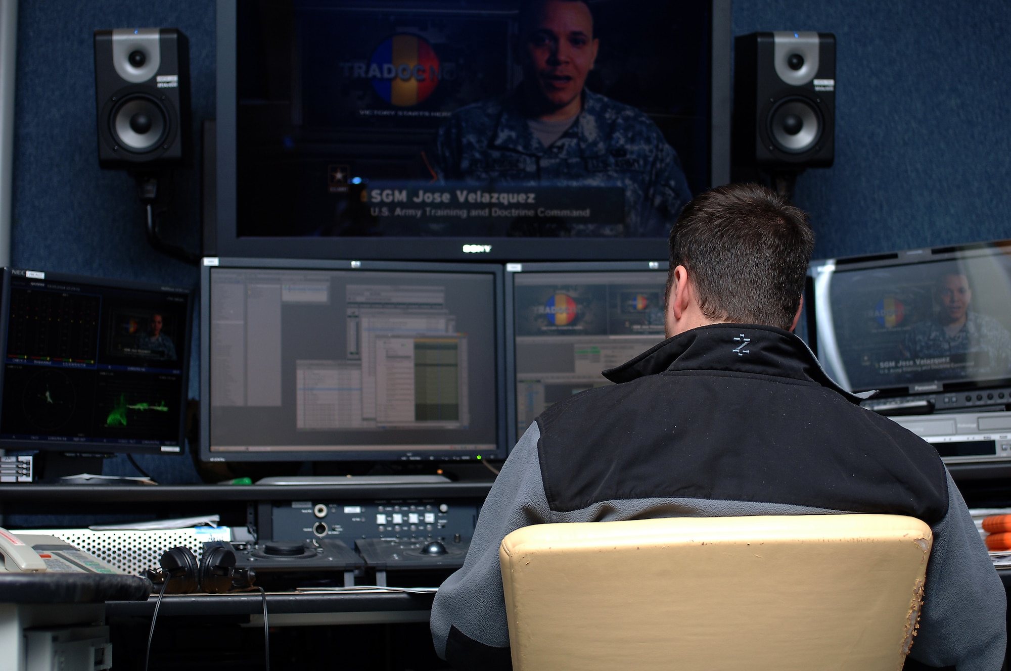 Tim Hupalo, Enterprise Multimedia Center video editor, edits a video project at Fort Eustis, Va., March 25, 2014. EMC’s audio/visual team provides audio and video systems for conferences, ceremonies, public service announcements and other major events. (U.S. Air Force photo by Senior Airman Teresa J.C. Aber/Released)