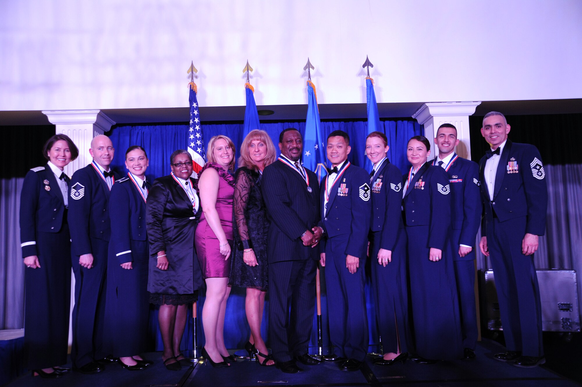 Air Force District of Washington Annual Awards winners pose for a photo with AFDW Commander Maj. Gen. Sharon K. G. Dunbar and AFDW Command Chief Master Sgt. Jose LugoSantiago during the awards ceremony at Joint Base Anacostia-Bolling, D.C., March 21, 2014. AFDW is a direct reporting unit to Headquarters Air Force, reporting to the Chief of Staff of the Air Force. AFDW is also the parent command to the 11th Wing, 79th Medical Wing, 844th Communications Group and two ceremonial elements. (U.S. Air Force photo/Master Sgt. Tammie Moore)
