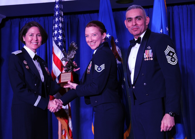 Staff Sgt. Samantha Navarrete accepts the 2013 Air Force District of Washington Annual Awards Military Volunteer of the Year trophy from AFDW Commander Maj. Gen. Sharon K. G. Dunbar and AFDW Command Chief Master Sgt. Jose LugoSantiago during the awards ceremony at Joint Base Anacostia-Bolling, D.C., March 21, 2014. Navarrete works at the 11th Wing, 811th Security Forces Squadron. (U.S. Air Force photo/Master Sgt. Tammie Moore) 