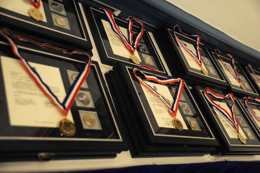 Medallions and recognition letters for the 2013 Air Force District of Washington Annual Awards nominees sit on display at the start of the awards ceremony at Joint Base Anacostia-Bolling, D.C., March 21, 2014. (U.S. Air Force photo/Master Sgt. Tammie Moore)