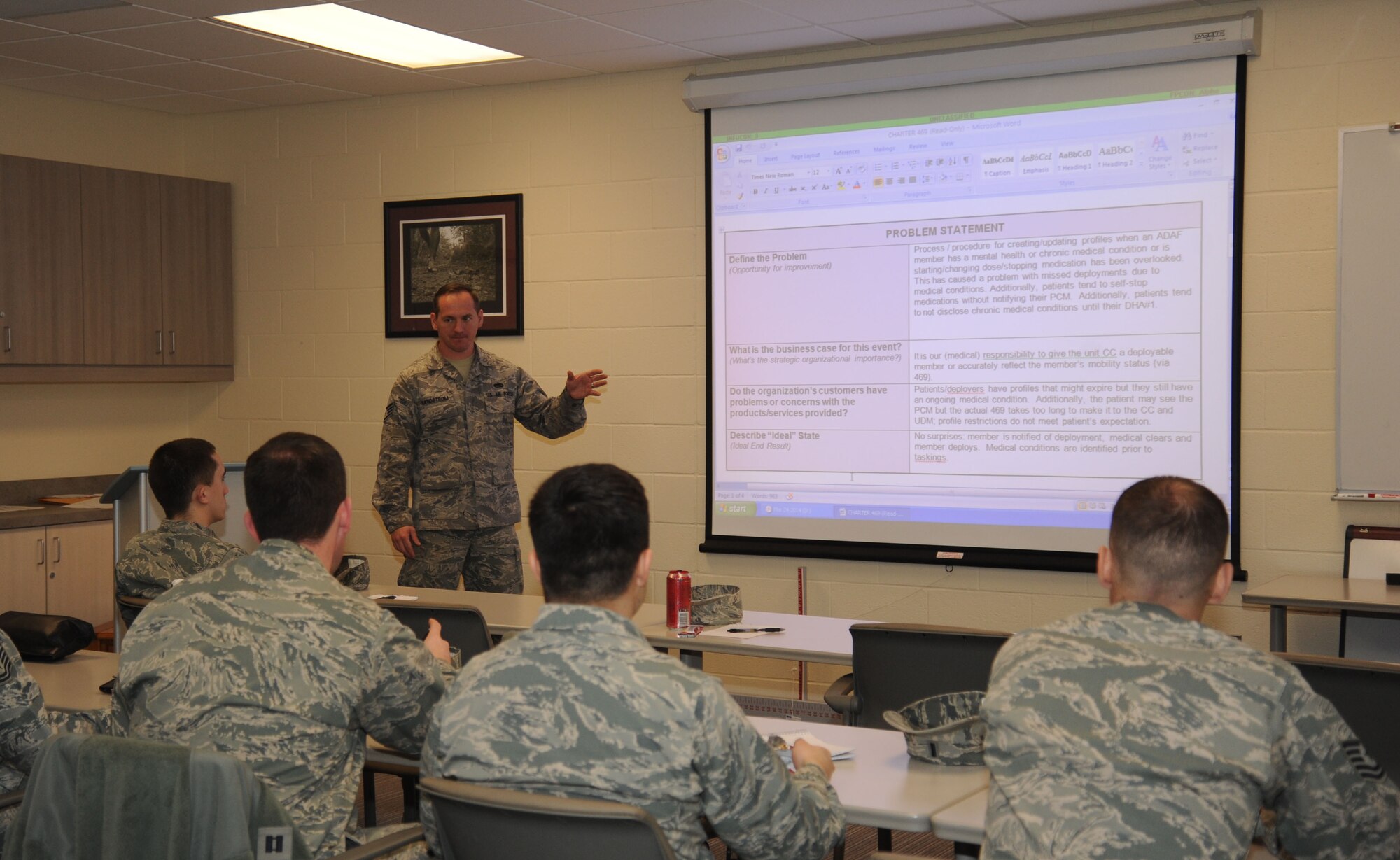 Staff Sgt. Evan Sandstrom speaks to AFSO21 attendees primarily from the 92nd Medical Group about inefficiency identification procedures at Fairchild Air Force Base, Wash., March 24, 2014. AFSO21 is an Air Force program that seeks to eliminate wasteful practices. Sandstrom is the 92nd Air Refueling Wing AFSO21 facilitator. (U.S. Air Force photo by Airman 1st Class Sam Fogleman/Released)