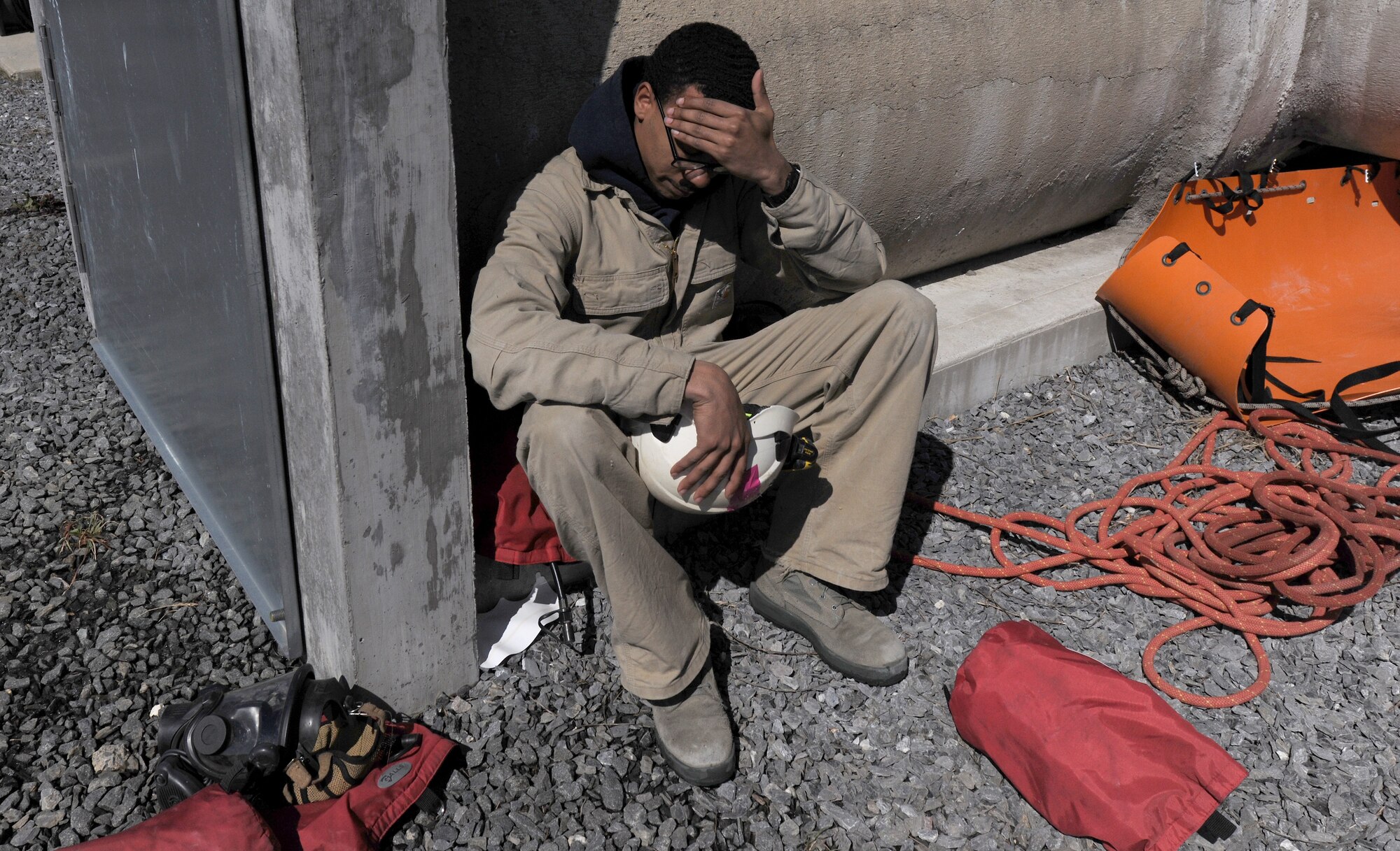 Airman 1st Class Tevin Charles, 11th Civil Engineer Squadron firefighter, takes a break after aiding in a rescue scenario in a confined space at the Fire Training Area on Joint Base Andrews, Md., March 19, 2014. The Fire Rescue 1 trainees were out in the field and classroom for approximately 11 hours a day, for 12 days straight. (U.S. Air Force photo/Airman 1st Class Nesha Humes)