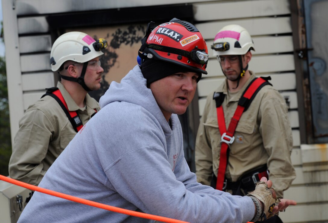 Staff Sgt. Brandon Pelkey, North Carolina Air National Guard rescue instructor, talks to Fire Rescue 1 trainers on how to repel off of buildings at the Fire Training Area on Joint Base Andrews, Md., March 12, 2014. (U.S. Air Force photo/Airman 1st Class Nesha Humes)