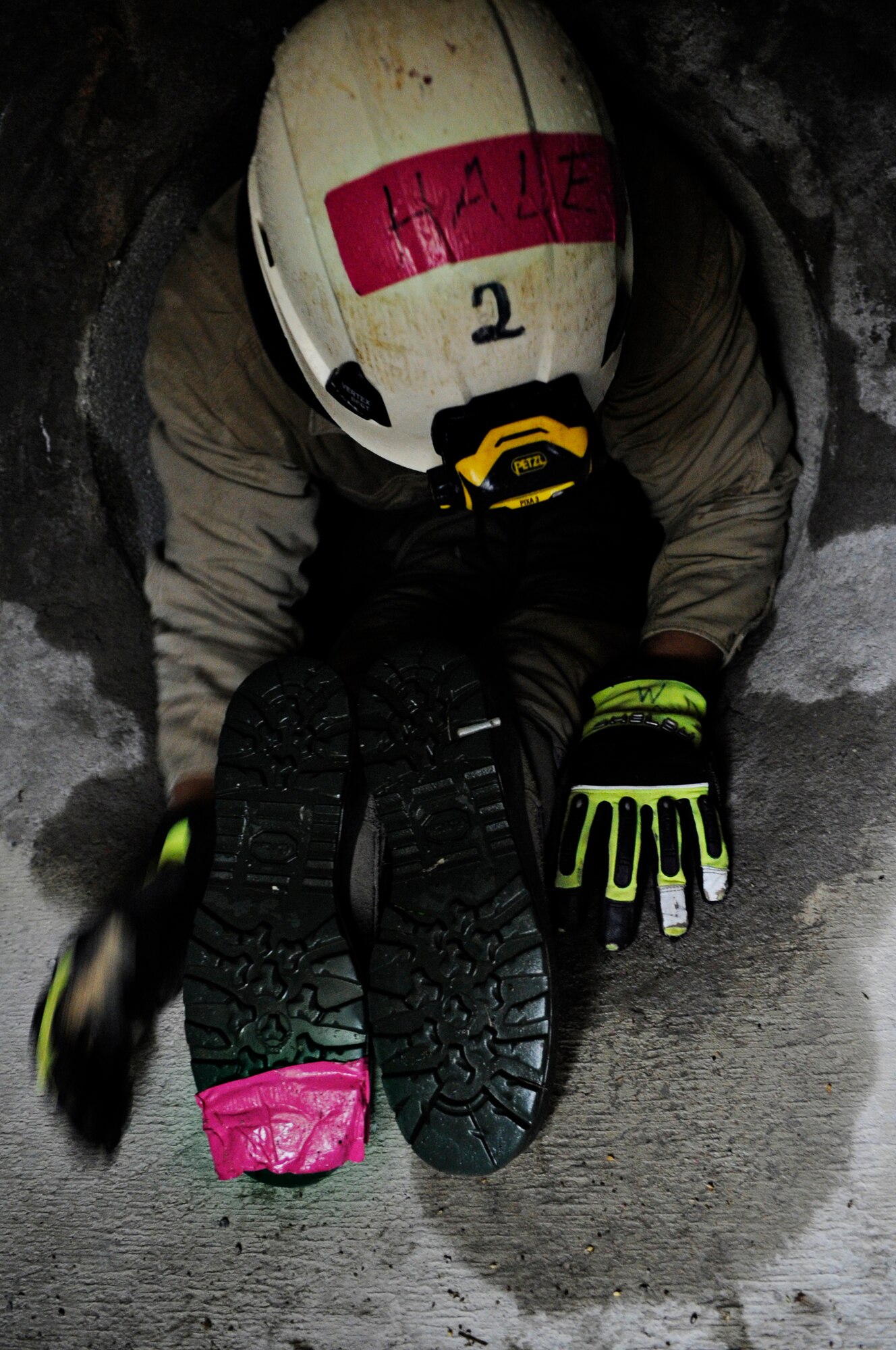 Staff Sgt. Christopher Hale, 11th Civil Engineer Squadron fire protection crew chief, crawls over an airman in one of the horizontal confined space areas at the Fire Training Area on Joint Base Andrews, Md., March 19, 2014. (U.S. Air Force photo/Airman 1st Class Nesha Humes)