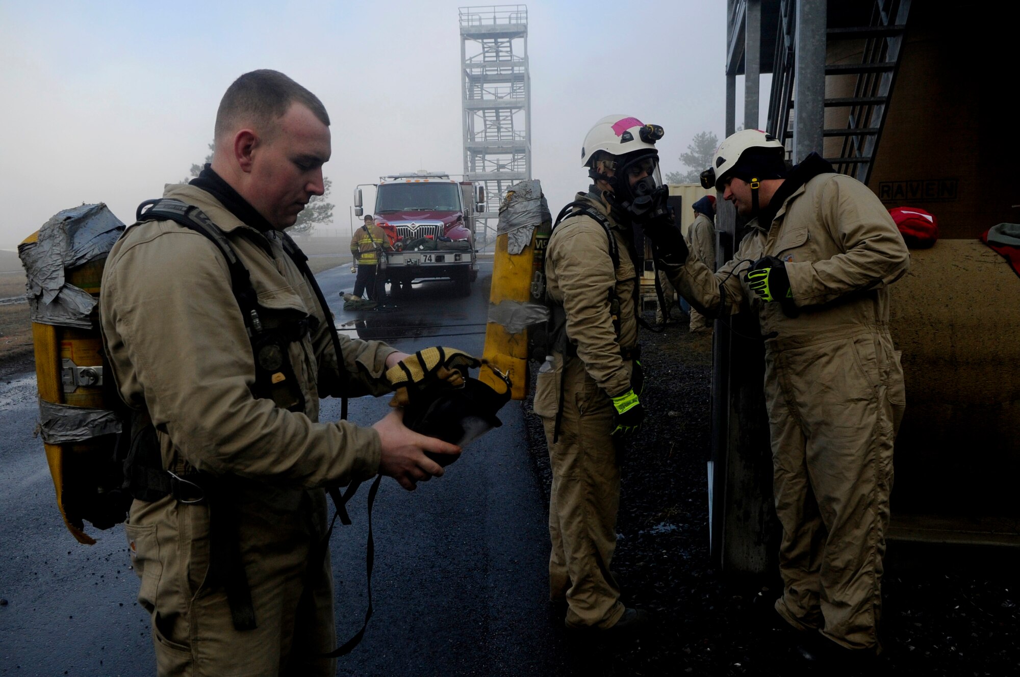 Staff Sgt. Jeremy Lundgren prepares to apply his mask in preparation for a confined horizontal space rescue scenario at the Fire Training Area on Joint Base Andrews, Md., March 19, 2014. Lundgren is the 633rd Civil Engineer Squadron fire protection crew chief from Joint Base Langley-Eustis, Va. (U.S. Air Force photo/Airman 1st Class Nesha Humes)