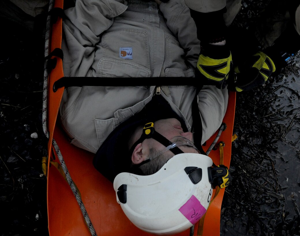 Tech. Sgt. David Webster plays victim during a rescue scenario at the Fire Training Area on Joint Base Andrews, Md., March 19, 2014. Webster is the 11th Civil Engineering Squadron assistant chief. (U.S. Air Force photo/Airman 1st Class Nesha Humes)