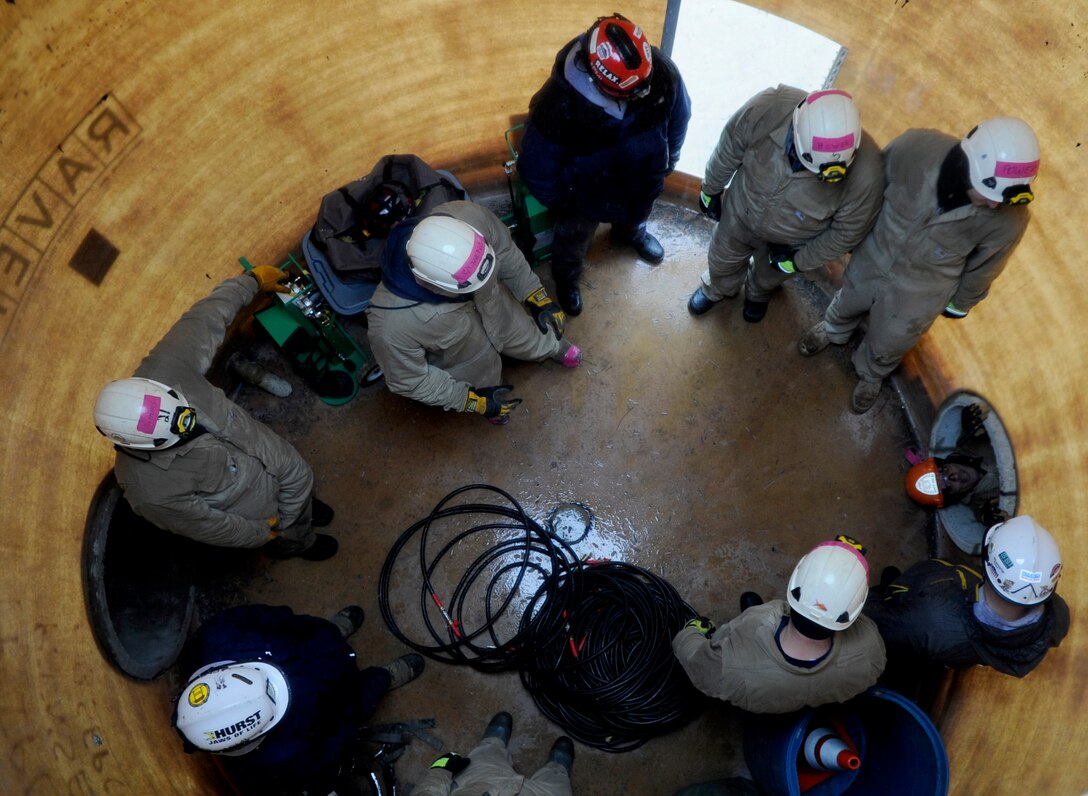 Fire Rescue 1 trainees take turns crawling through the horizontal confined space Fire Training Area on Joint Base Andrews, Md., March 19, 2014. (U.S. Air Force photo/Airman 1st Class Nesha Humes)