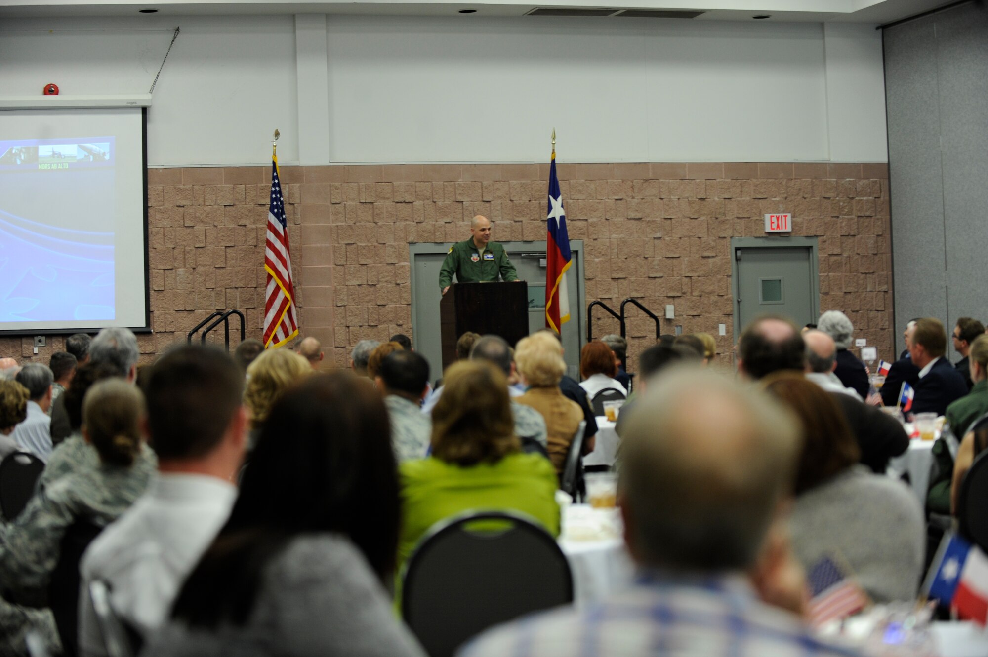 U.S. Air Force Col. Michael Bob Starr, 7th Bomb Wing commander, speaks to members of the Abilene Military Affairs Committee March 21, 2014, at the Abilene Civic Center in Abilene, Texas. During the event Starr recognized several Airmen who distinguished themselves through their performance overseas and at home. (U.S. Air Force photo by Airman 1st Class Alexander Guerrero/Released)