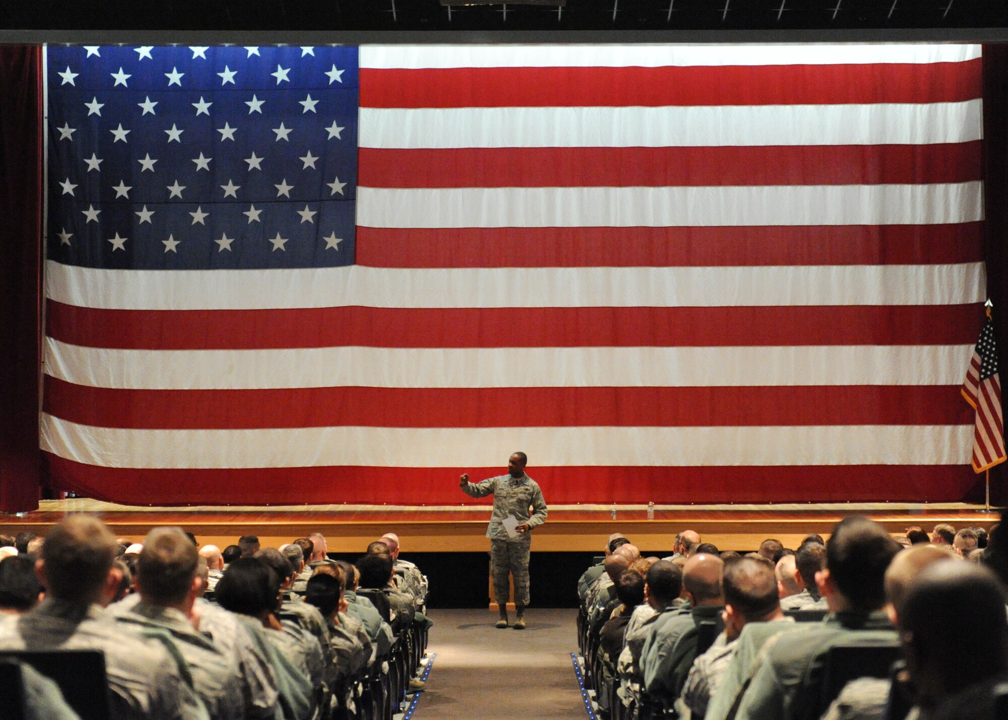 Lt. Gen. Darren McDew, 18th Air Force commander, speaks to Team Dover Airmen during an all-call March 25, 2014, at the base theater on Dover Air Force Base, Del. Lt. Gen. McDew spoke to Airmen about leadership and force reduction and how those issues will affect the Air Force. (U.S. Air Force photo/Roland Balik)