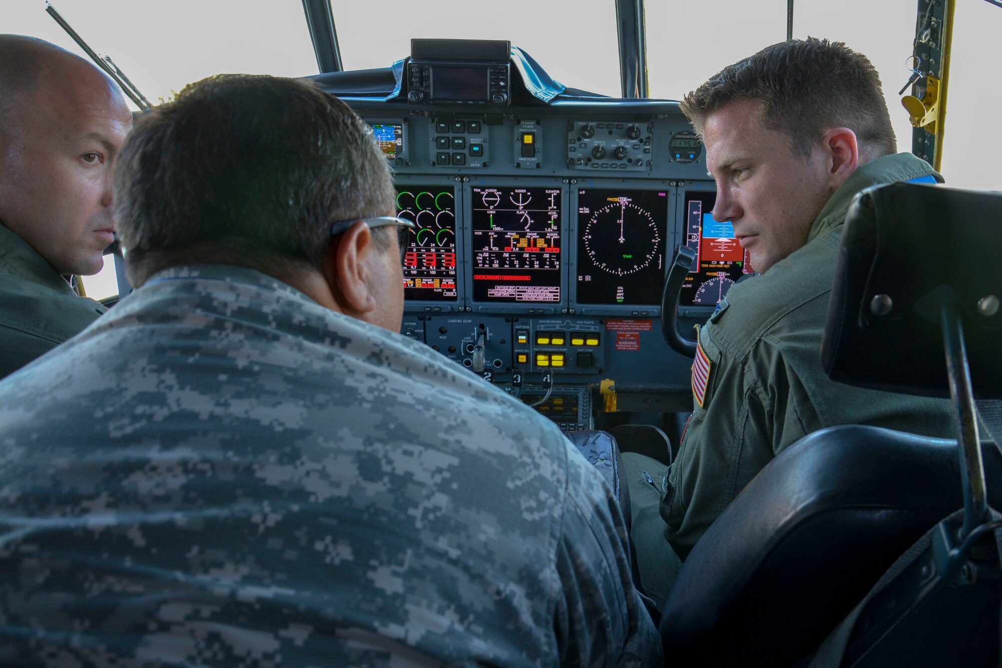 Maj. Josh Ritzmann (far left) and 1st Lt. Jacob Fuhrmann (far right), C-130 pilots for the Texas Air National Guard, discuss C-130 operations with a Chilean maintenance expert during the first day of the FIDAE Air Show in Santiago, Chile, March 25. Nearly 60 U.S. airmen are participating in subject matter expert exchanges with Chilean air force counterparts during FIDAE, and as part of the events will host static displays of the C-130 Hercules and F-16 Fighting Falcon. The exchanges, conducted regularly throughout the year, involve U.S. Airmen sharing best practices and procedures to build partnerships and promote interoperability with partner-nations throughout South America, Central America and the Caribbean. (U.S. Air Force photo by Capt. Justin Brockhoff/Released)