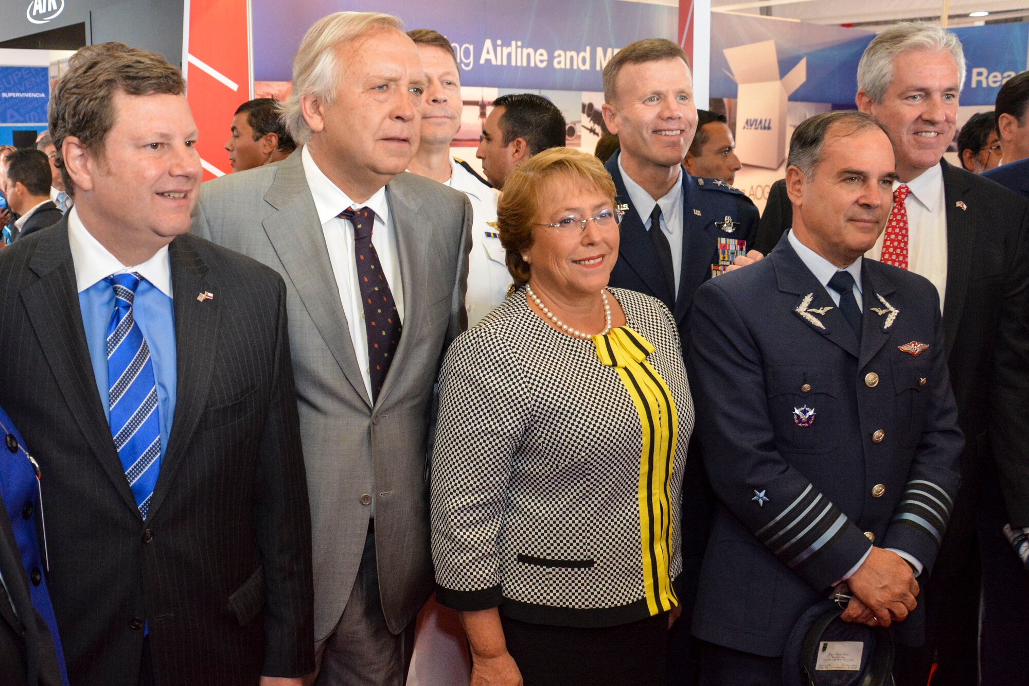 Chilean President Michelle Bachelet poses for a photo with (from left) Mr. Michael Hammer, U.S. Ambassador to Chile, Jorge Burgos, Chilean Minister of Defense, U.S. Navy Vice Adm. Joseph Rixey, director of the Defense Security Cooperation Agency, U.S. Air Force Lt. Gen. Tod Wolters, 12th Air Force (Air Forces Southern) commander, Gen. Jorge Rojas, commander-in-chief of the Chilean air force, and Tom Kallman, president and CEO of Kallman Worldwide, in the U.S. exhibition pavilion at the FIDAE Air Show in Santiago, Chile, March 25. Nearly 60 U.S. airmen are participating in subject matter expert exchanges with Chilean air force counterparts during FIDAE, and as part of the events will host static displays of the C-130 Hercules and F-16 Fighting Falcon. The exchanges, conducted regularly throughout the year, involve U.S. Airmen sharing best practices and procedures to build partnerships and promote interoperability with partner-nations throughout South America, Central America and the Caribbean. (U.S. Air Force photo by Capt. Justin Brockhoff/Released)