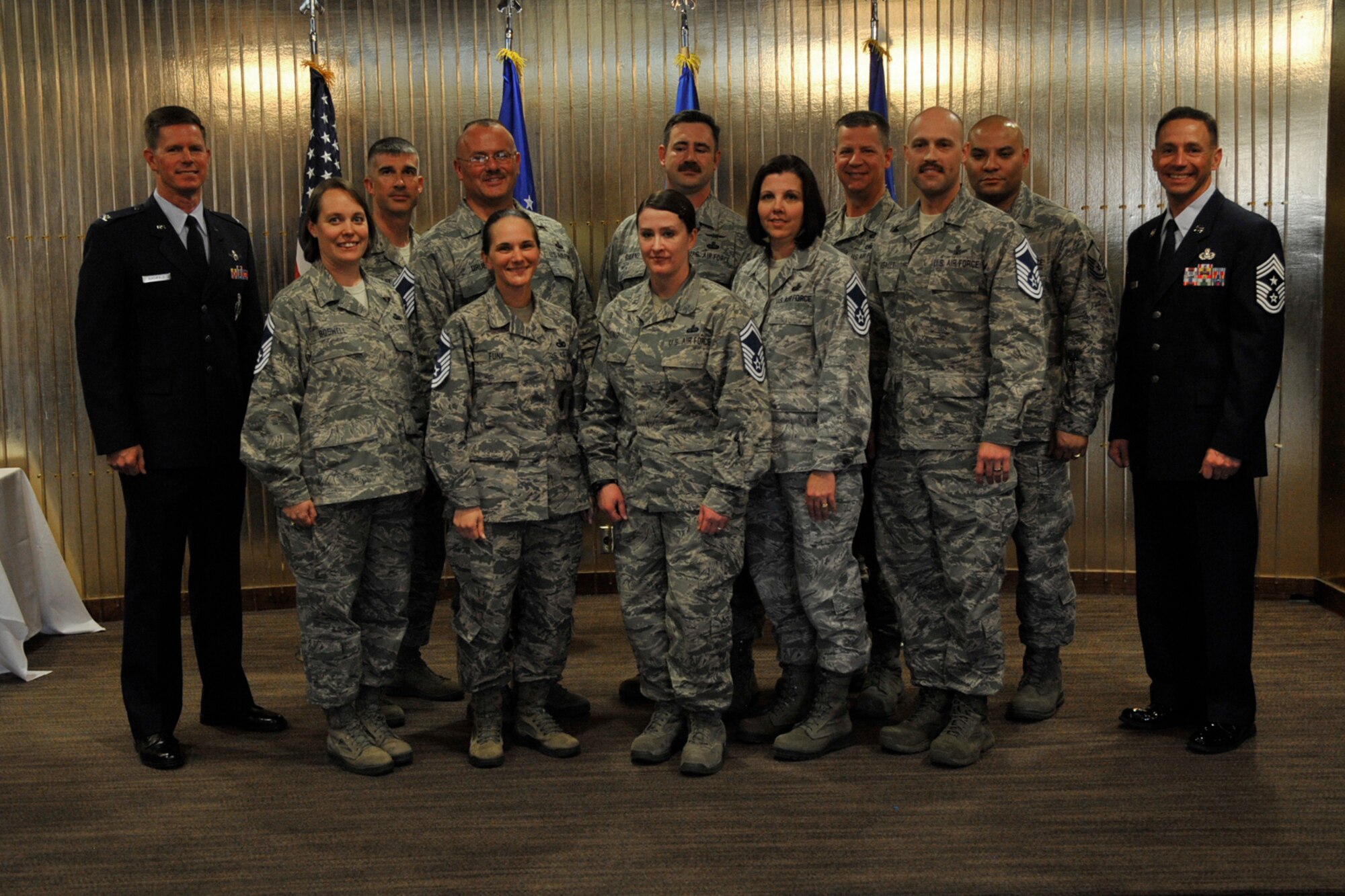 PETERSON AIR FORCE BASE, Colo. – Col. Richard Burchfield (left), 21st Space Wing IMA to the commander, and Chief Master Sgt. Richard Redman (right), 21st SW command chief, present stripes to Team Pete’s newest crop of senior master sergeants March 21 at The Club. Eighteen master sergeants from Team Pete were selected for promotion to E-8. (U.S. Air Force photo/Robb Lingley)