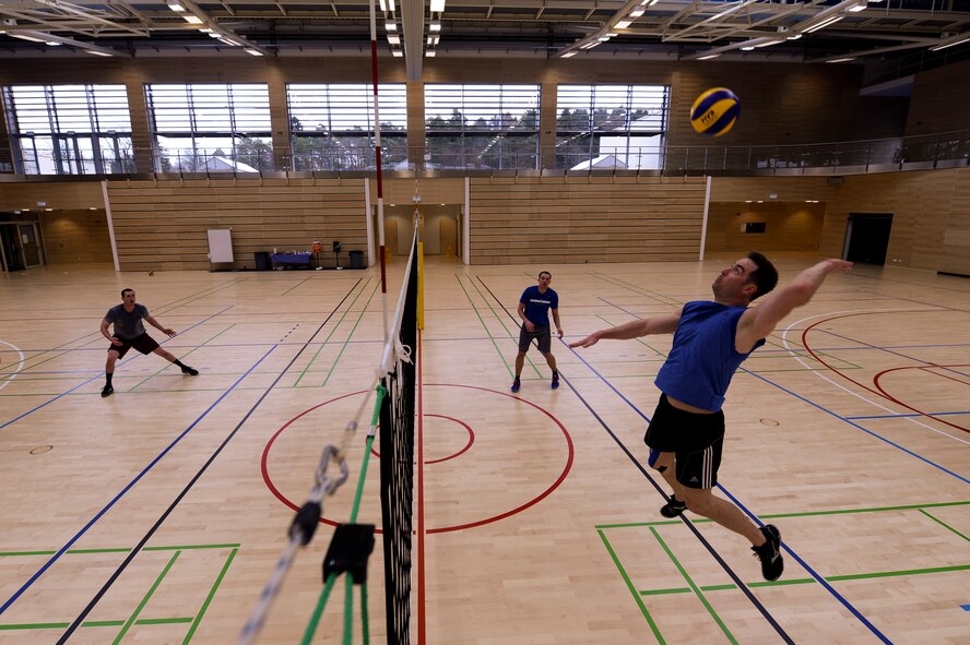Brian Redenbaugh, a U.S. Air Forces in Europe and Air Forces Africa men's volleyball team player, prepares to hit a volleyball during day two of their training camp March 22, 2014, at Spangdahlem Air base, Germany. The team’s training camp lasted four days with two practice sessions a day. (U.S. Air Force photo by Senior Airman Rusty Frank/Released)