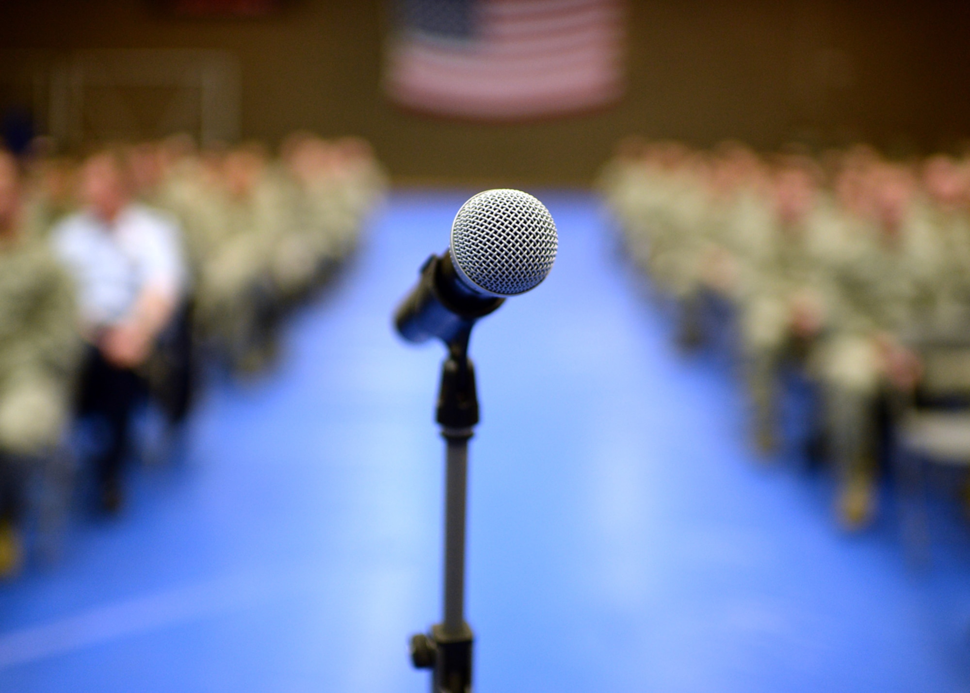 A microphone rests in front of more than 300 U.S. Air Force Airmen in the Skelton Memorial Fitness Center at Spangdahlem Air Base, Germany, March 24, 2014. The leadership of the 52nd Fighter Wing addresses Airmen during mass briefings, or commander’s calls, throughout the year, and this one targeted the wing's enlisted corps. (U.S. Air Force photo by Staff Sgt. Daryl Knee/Released)