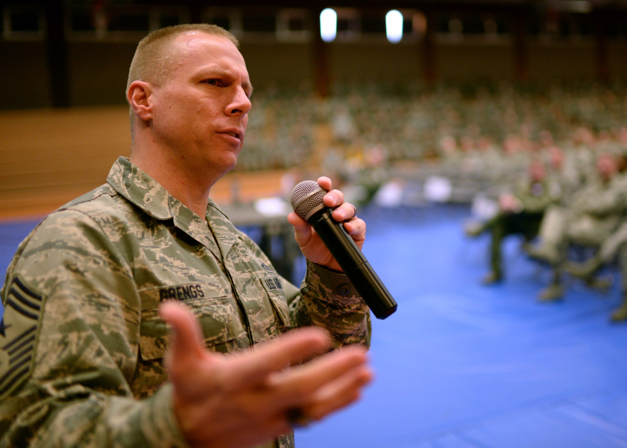 U.S. Air Force Chief Master Sgt. Matt Grengs, 52nd Fighter Wing command chief from Longmont, Colo., talks with base Airmen during a mass briefing in the Skelton Memorial Fitness Center at Spangdahlem Air Base, Germany, March 26, 2014. Base leadership often discusses current issues affecting Airmen and shares information about the future of the Air Force during these commander’s calls. (U.S. Air Force photo by Staff Sgt. Daryl Knee/Released)
