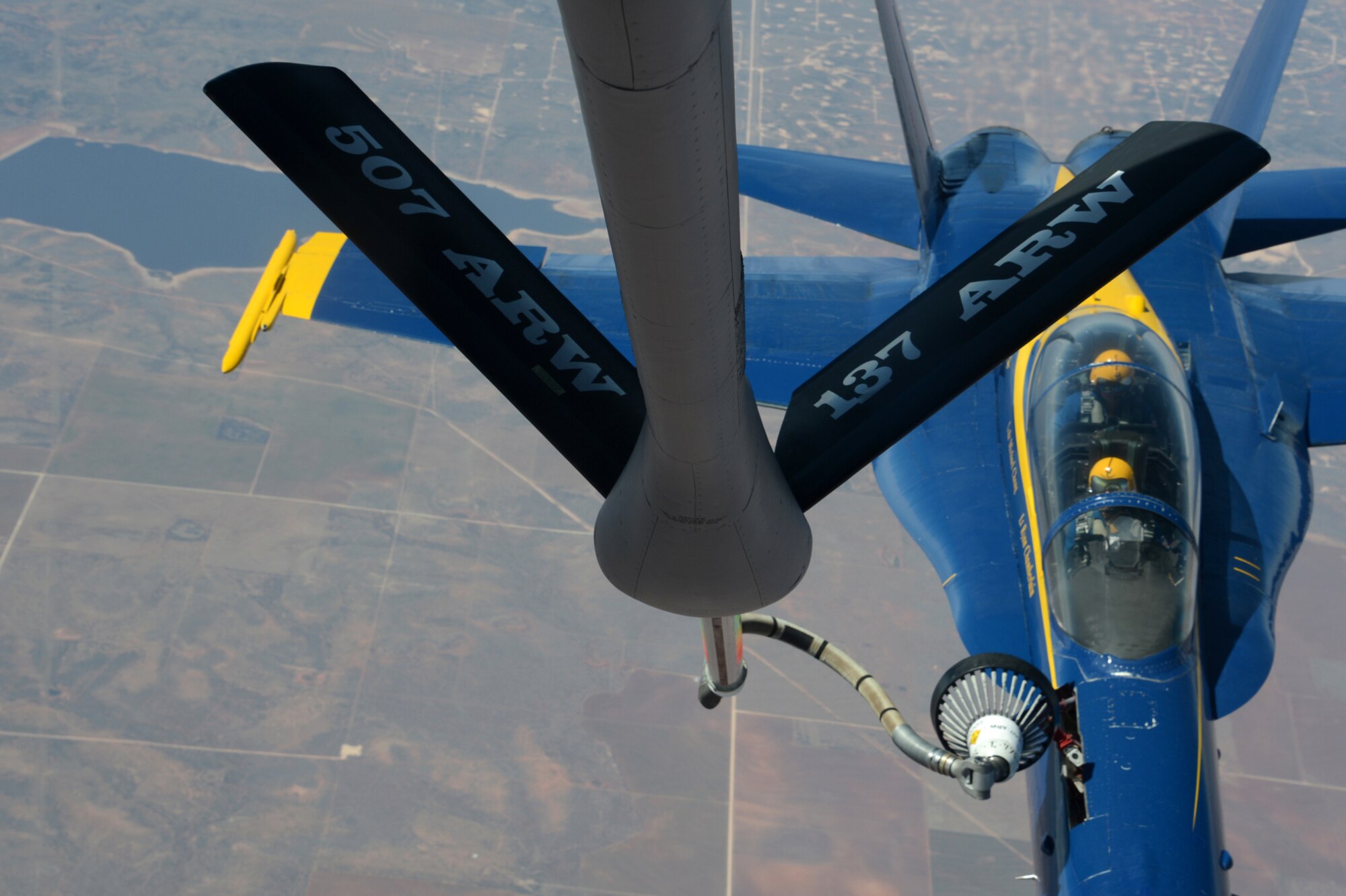 A Crew from the 137th Oklahoma Air National Guard Air Refueling Wing had the rare opportunity to provide aerial refueling support to a Navy Blue Angels squadron Monday March 24, 2014.  The squadron was making their way back from their winter home at Naval Air Facility, El Centro Calif., to Naval Air Station, Pensacola Fla., to prepare for the upcoming season.  The 137th ARW picked up the Blue Angels in New Mexico and refueled six single seat F/A 18 Hornets and a two-seat trainer all the way to eastern Texas.  The KC-135 Stratotanker is fitted with a drogue in order to perform aerial refueling for Naval aircraft.  (U.S. Air Force photo/Senior Master Sgt. Kevin Tucker)