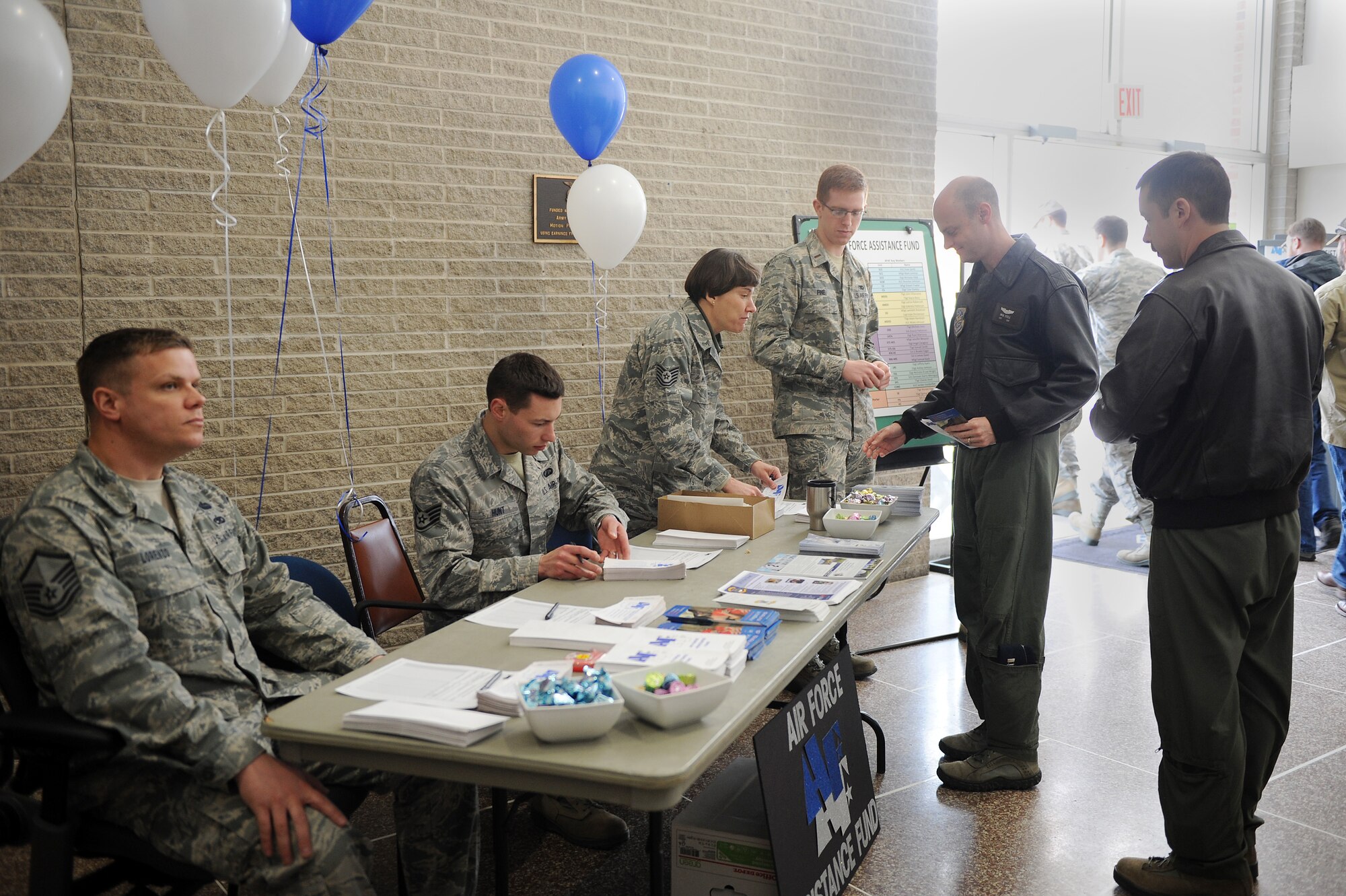 Members of Team Scott man the Air Force Assistance Fund table during commanders call Mar. 25, 2014, Scott Air Force ,Ill.  The AFAF event kicked off today, and is running til May 2. (U.S. Air Force photo/Senior Airman Divine Cox)
