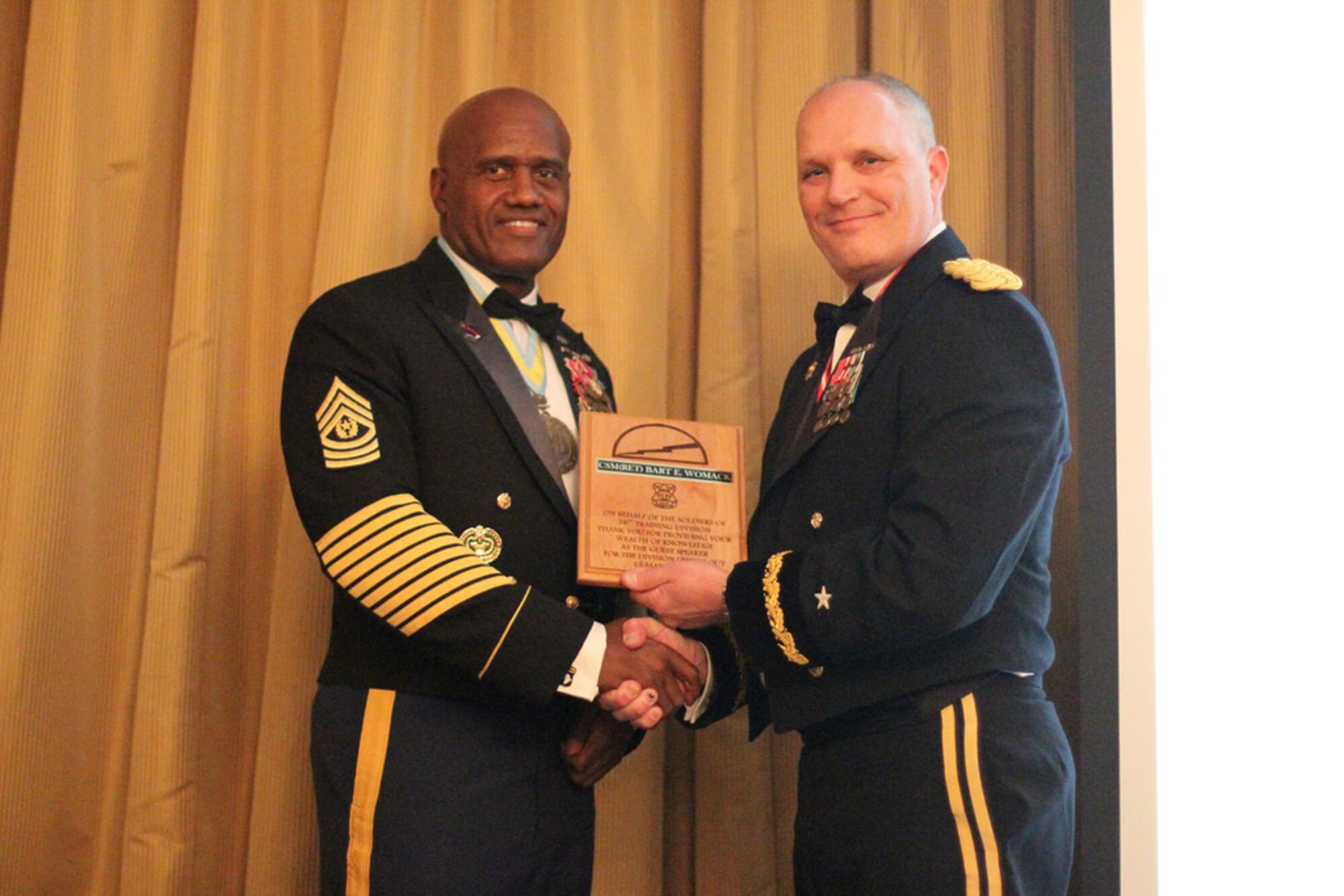 Brig. Gen. Bruce E. Hackett, commander of the 78th Training Division, presents retired Command Sgt. Maj. Bart Womack a token of appreciation for serving as guest speaker at the division’s annual Dining Out, March 15, 2014, at Joint Base McGuire-Dix-Lakehurst, N.J. (U.S. Army photo by Sgt. Errol Cadet/Released)