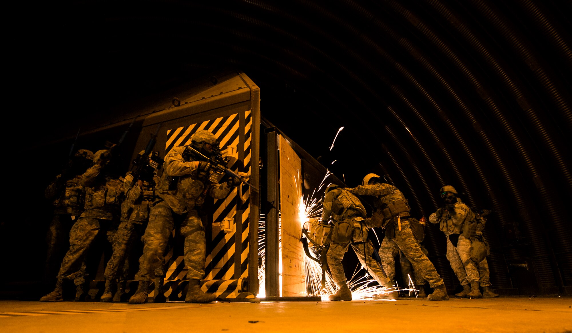 Airmen breach a door during Battlefield Leaders, Assaulters Course, March 12, 2014, Ramstein Air Base, Germany. Members of the 435th SFS taught Airmen a variety of skills during the course, including advance tactics, shooting and leadership. (U.S. Air Force photo/Senior Airman Damon Kasberg)