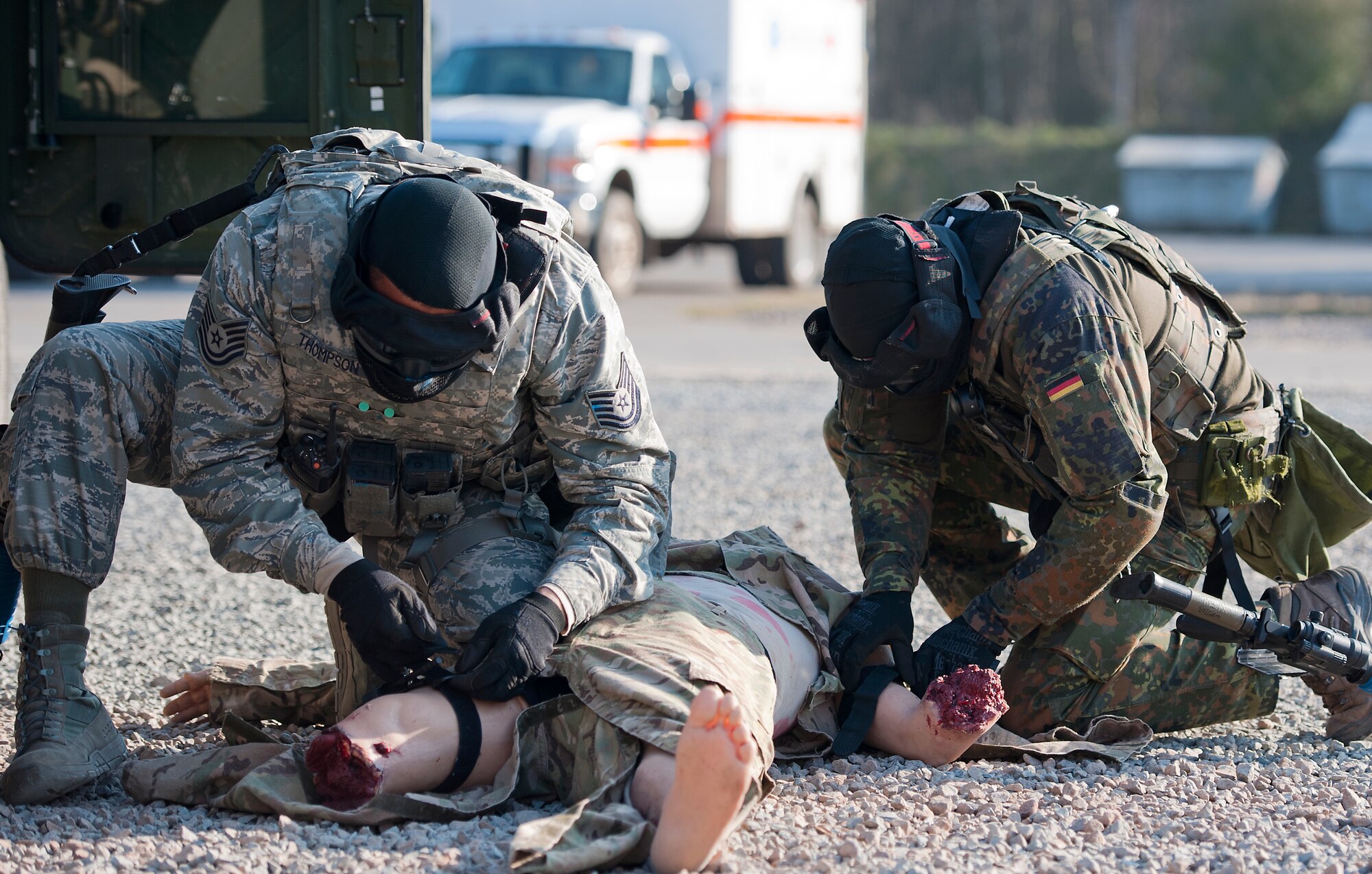Tech. Sgt. Jarvis O. Thompson (left), 103rd MUNNS, and Master Sgt. Christoph Czaja, German air force security forces squadron member, perform self-aid buddy care on a simulated casualty during the Battlefield Leaders, Assaulters Course, March 12, 2014, Ramstein Air Base, Germany. Service members throughout Europe participated in the course to learn advance tactics, shooting and leadership skills, which they implemented on the last day during a final field training exercise. (U.S. Air Force photo/Senior Airman Damon Kasberg)
