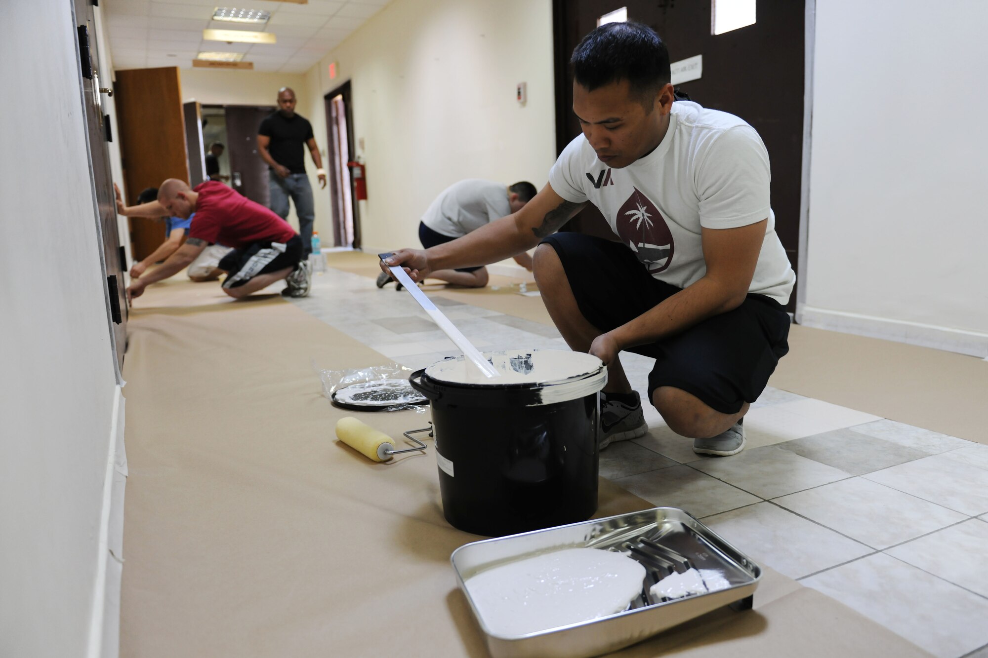 Airmen from the 728th Air Mobility Squadron and Airmen enrolled in Airman Leadership School class 14-3 paint the hallways and classrooms in the ALS schoolhouse March 22, 2014, Incirlik Air Base, Turkey.  Each ALS class participates in one community activity and leaves behind one legacy project while enrolled in the course. (U.S. Air Force photo by Senior Airman Nicole Sikorski/Released)

