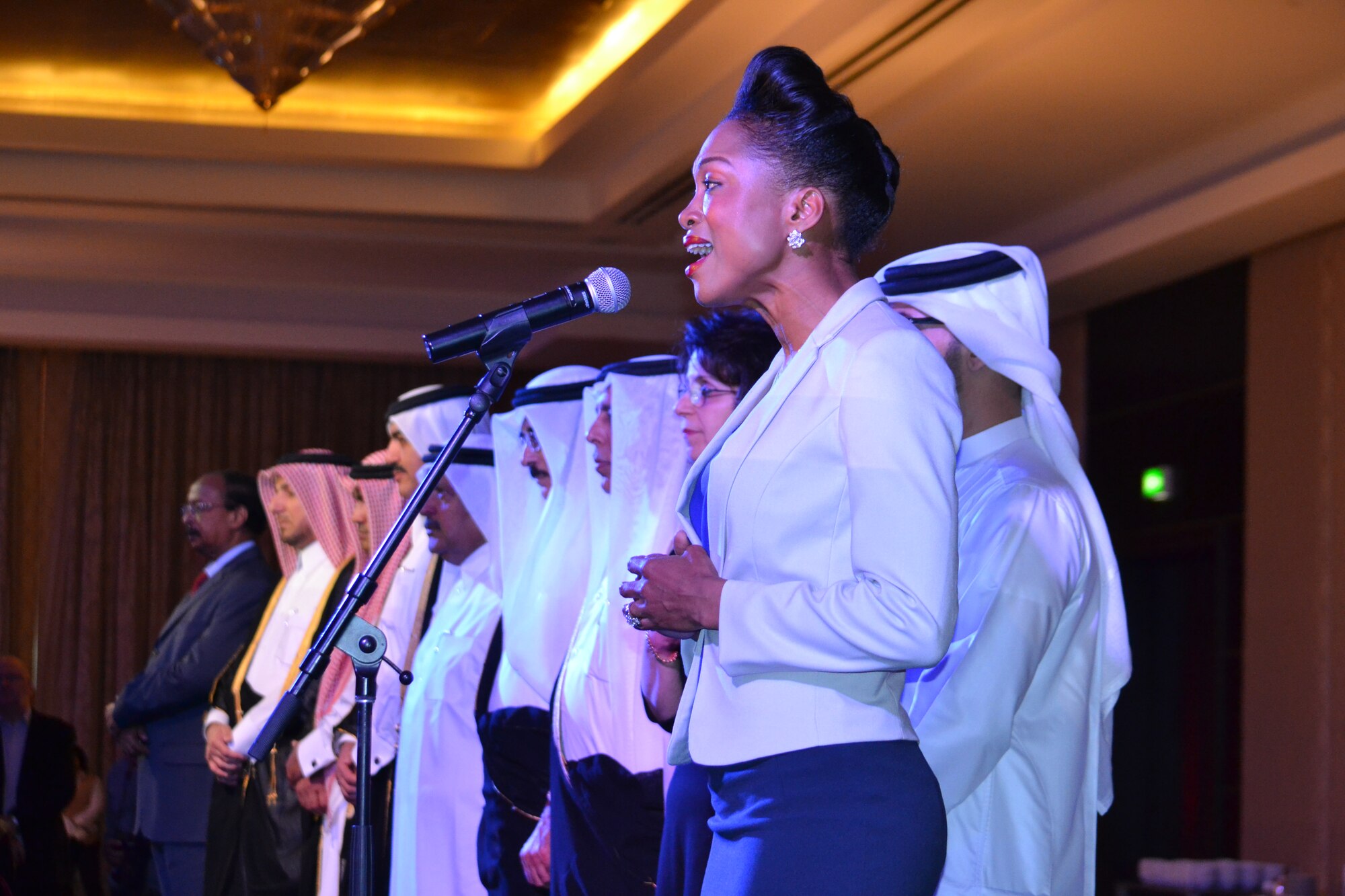 Capt. Maxine Reyes, a budget officer for U.S. Forces-Afghanistan sings the national anthem at the St. Regis Hotel in downtown Doha, Qatar on Mar. 23, 2014.  Reyes was selected by the U.S. Embassy-Doha to sing the anthem during the American National Day celebration, honoring July 4th independence and furthering developing the long-lasting relationships between the United States and Qatar.  In attendance were several ministers from the Qatar government, as well as ambassadors from other countries and top military officials in the country.  Reyes is a native of Miami, Fla. and deployed from Fort Jackson, S.C.  (U.S. Air Force Photo by Maj. Nicole David)