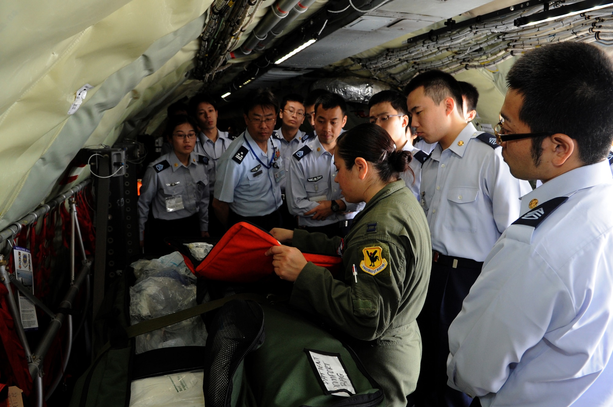 U.S. Air Force Capt. Esmeralda Salazar, 18th Aeromedical Evacuation Squadron aeromedical flight nurse, briefs and displays various medical supplies used on air evacuation missions to Japan Air Self Defense Force members Kadena Air Base, Japan, March 20, 2014. Supplies such as laryngoscopes, obstetric kits, and Foley kits are all some typical medical items used for patient comfort during medical evacuation missions.(U.S. Air Force photo by Airman 1st Class Keith James)