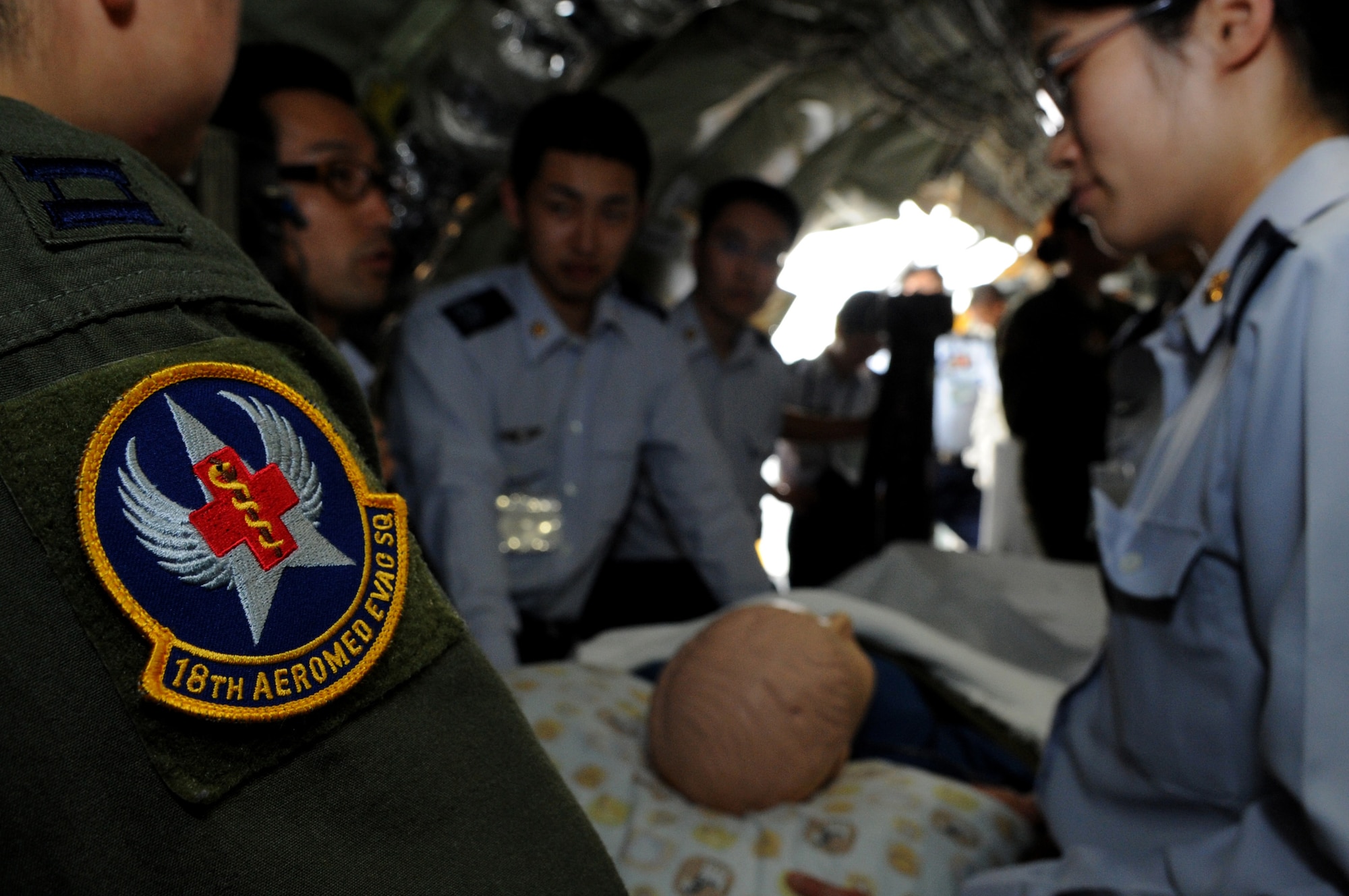 U.S. Air Force Capt. Esmeralda Salazar, 18th Aeromedical Evacuation Squadron aeromedical flight nurse, displays how to load and care for a patient aboard a KC-135 Stratotanker to members of the Japanese Air Self Defense Force during a tour on Kadena Air Base, Japan, March 20, 2014.The JASDF members learned about the 18th AES mission and the KC-135 Stratotanker, one of several different aircraft that can be utilized for medical evacuation missions. Other aircraft that provide aeromedical evacuation capabilities include the C-17 Globemaster III, KC-10 Extender, and C-130 Hercules.   (U.S. Air Force photo by Airman 1st Class Keith James)
