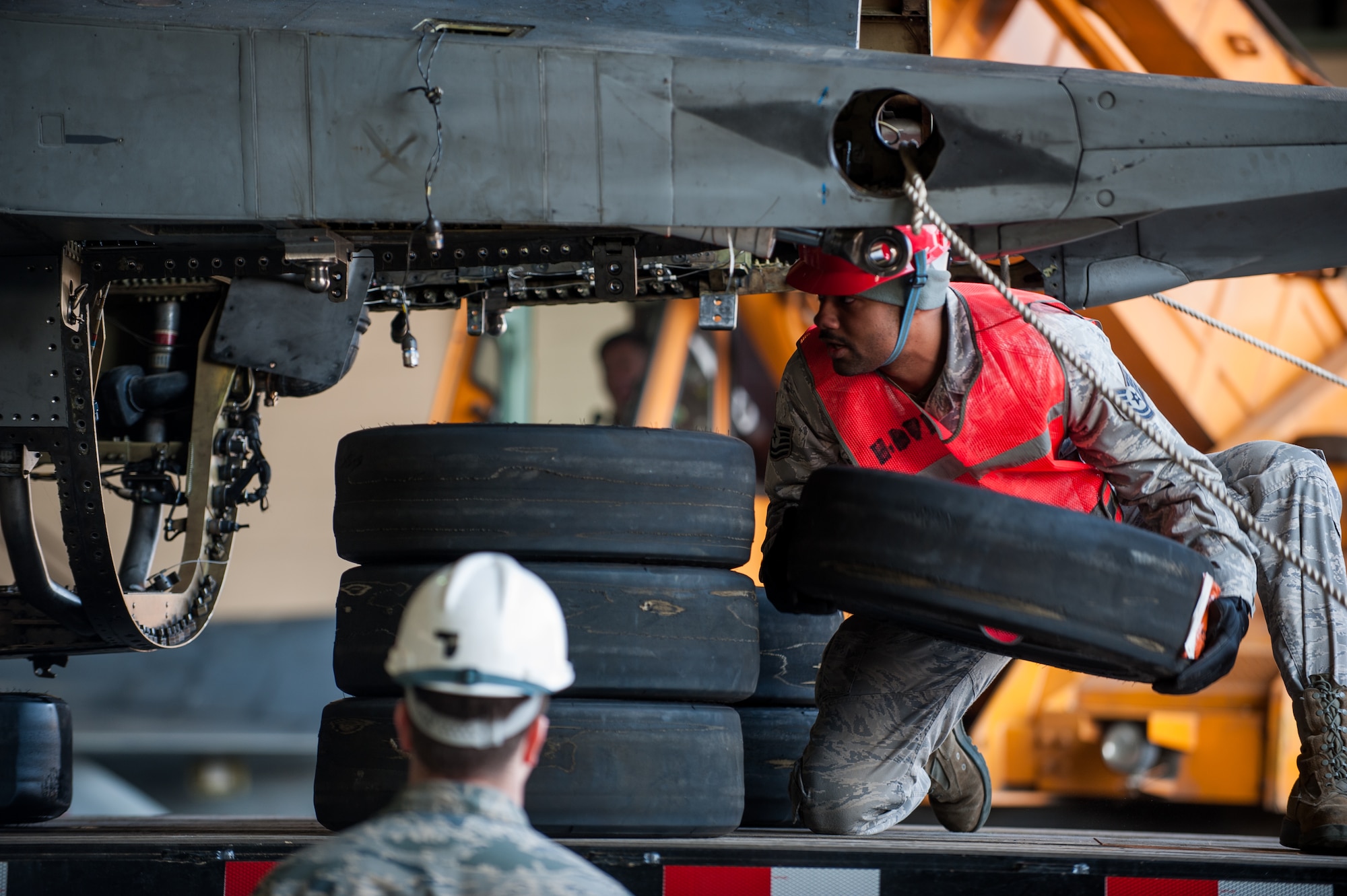 Tech. Sgt. Marvin Burton, 8th Maintenance Squadron crash damage disable aircraft team leader, places tires to stabilize an F-16 for transportation at Kunsan Air Base, Republic of Korea, Mar. 22, 2014. The crash recovery team chiefs were recertified and trained on damaged aircraft equipment for disposal. (U.S. Air Force photo by Staff Sgt. Clayton Lenhardt/Released)