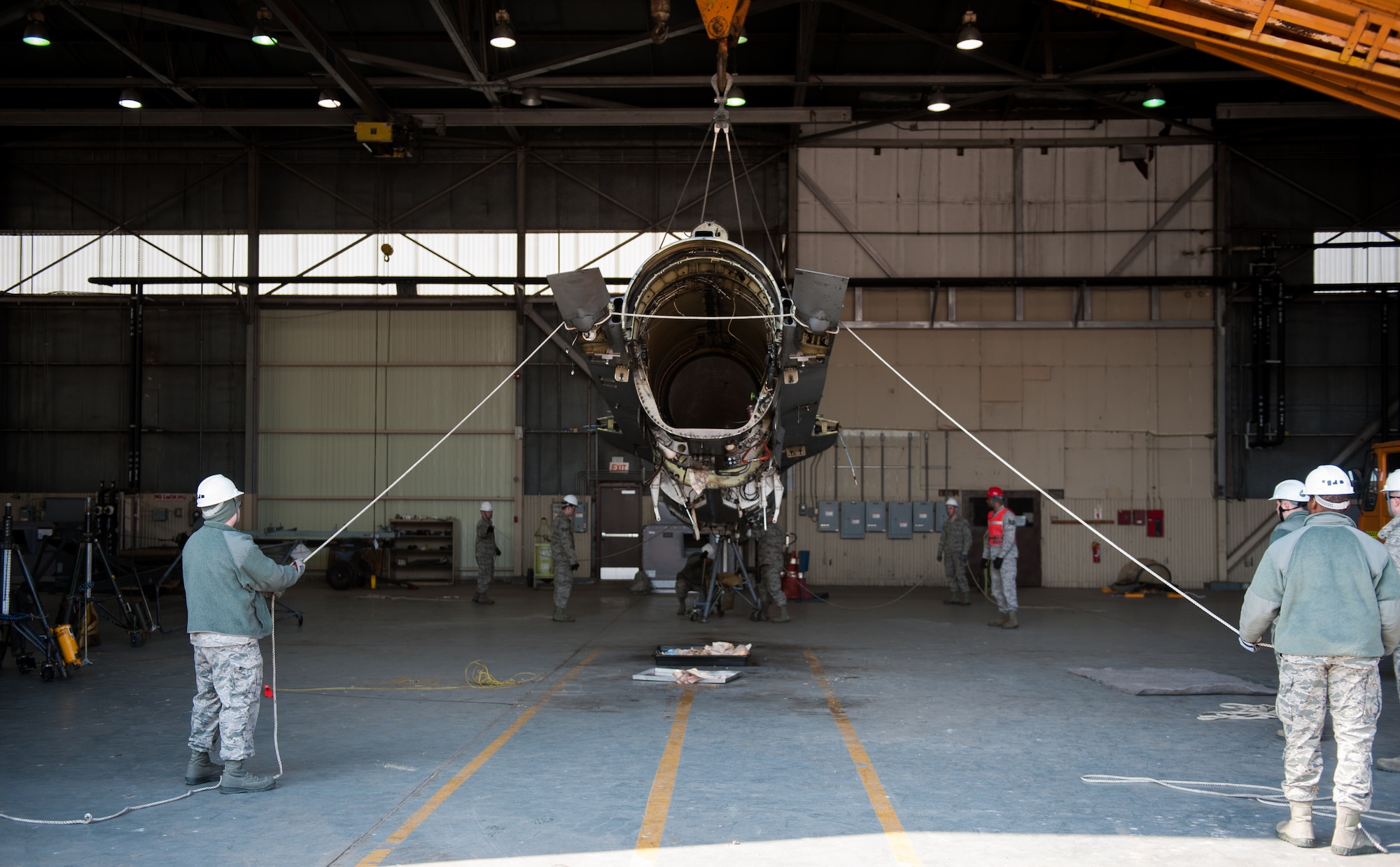 Airmen from the 8th Maintenance Squadron guide a damaged F-16 at Kunsan Air Base, Republic of Korea, Mar. 22, 2014. The crash recovery team chiefs were recertified and trained on damaged aircraft equipment for disposal. (U.S. Air Force photo by Staff Sgt. Clayton Lenhardt/Released)