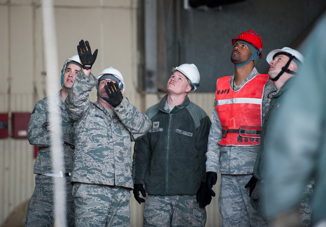 Airmen from the 8th Maintenance Squadron observe crane operations at Kunsan Air Base, Republic of Korea, Mar. 22, 2014. The crash recovery team chiefs were recertified and trained on damaged aircraft equipment for disposal. (U.S. Air Force photo by Staff Sgt. Clayton Lenhardt/Released)
