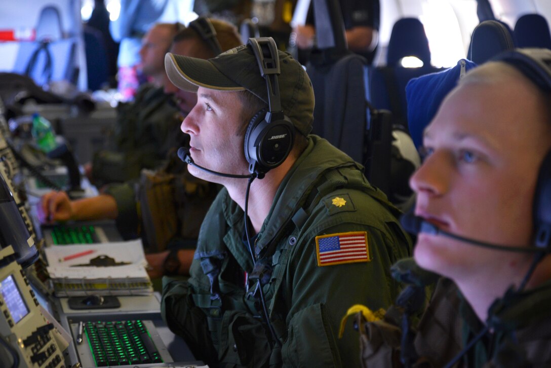 U.S. Navy Lt. Cmdr. Mike Trumbull monitors his workstation on a P-8A Poseidon at sea, March 24, 2014, during a mission to assist in the search for Malaysia Airlines Flight 370. Trumbull is a naval flight officer assigned to Patrol Squadron 16, which is deployed in the U.S. 7th Fleet area of responsibility supporting security and stability in the Indo-Asia-Pacific region. 