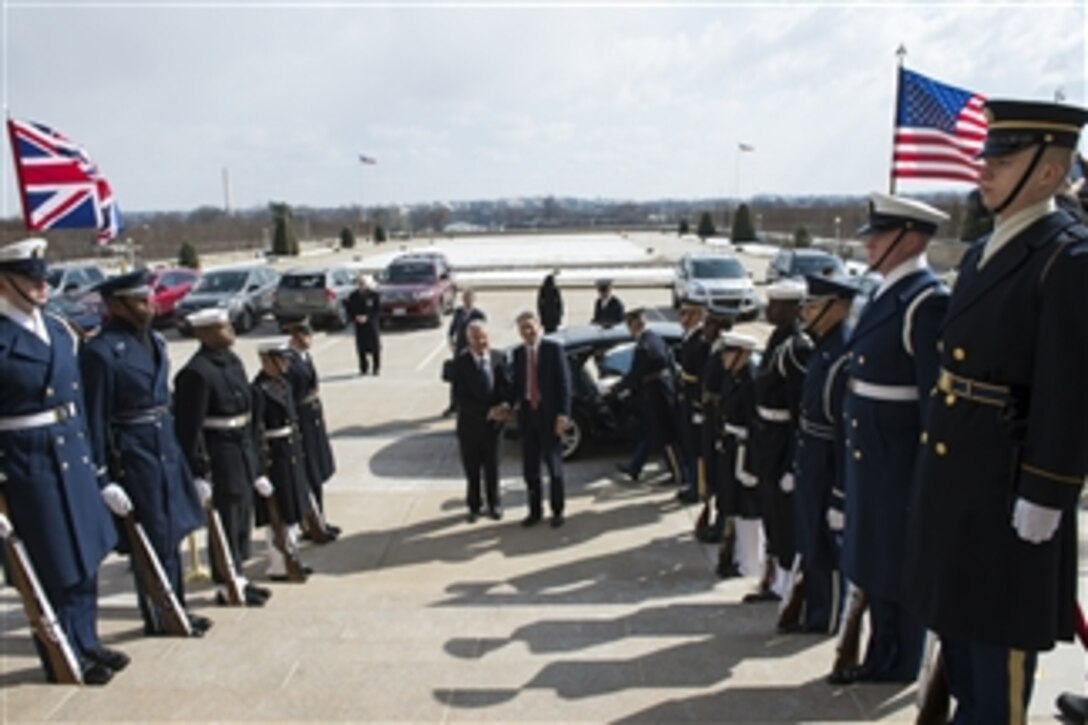 U.S. Defense Secretary Chuck Hagel, left, hosts an honor cordon to welcome British Defense Secretary Philip Hammond to the Pentagon, March 26, 2014. The two defense leaders met to discuss issues of mutual importance.