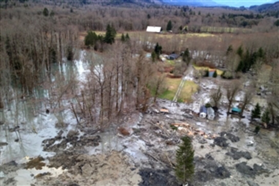 An aerial view shows the deadly mudslide in the Oso area of Snohomish County, Wash., March 22, 2014, as a U.S. Navy crew and three Navy firefighters assist with search and recovery efforts. The slide covered a square mile in a rural community about 55 miles northeast of Seattle. The Navy crew is based on Naval Air Station Whidbey Island, Wash.