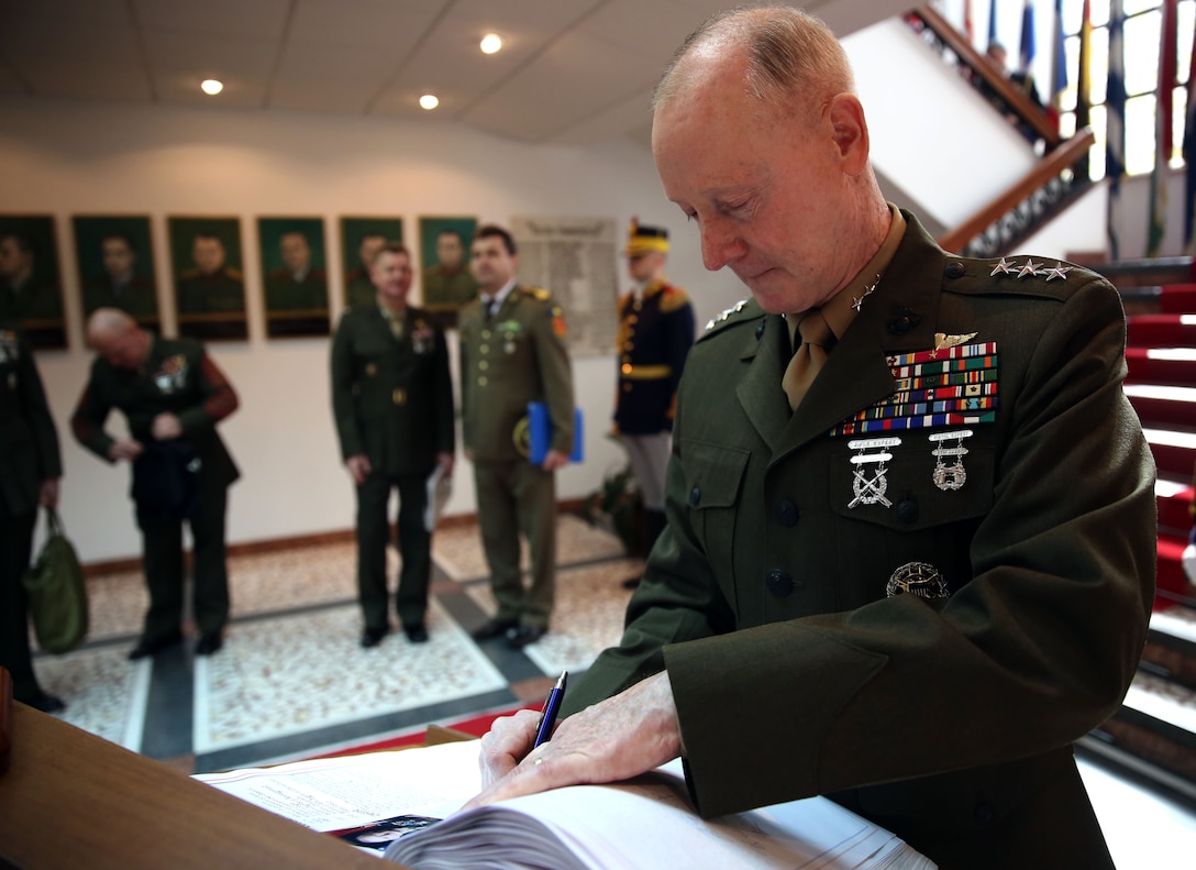 United State Marine Corps Lt. Gen. Richard Tryon, commander of U.S. Marine Corps Forces Command and U.S. Marine Corps Forces, Europe, signs a visitor’s logbook after meeting with Romanian Maj. Gen. Nicolae-Ionel Ciuca, chief of Romanian land forces, during Tryon’s official visit to Bucharest, March 18, 2014. Tryon visited with Romanian military officials to discuss continuing the good military relationship between the United States and Romania. United States military forces are currently in Romania assigned to Mihail Kogalniceanu Air Base and the two nations work together during much of the Black Sea Rotational Force deployment. Black Sea Rotational Force 14 is a contingent of Marines and sailors tasked with maintaining positive relations with partner nations, regional stability and increasing interoperability while providing the capability for rapid crisis response, as directed by U.S. European Command, in the Black Sea, Balkan and Caucasus regions of Eastern Europe. (Official Marine Corps photo by Lance Cpl. Scott W. Whiting, BSRF PAO/ Released)