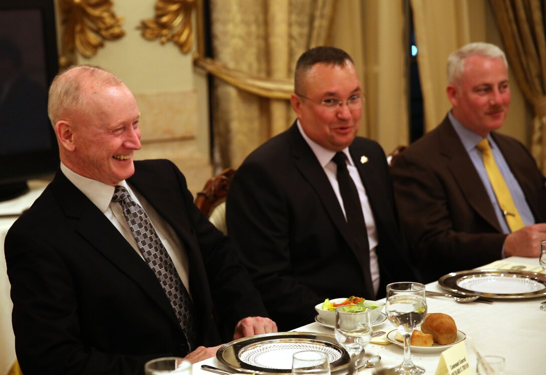 Lieutenant Gen. Richard Tryon (left), commander of U.S. Marine Corps Forces Command and U.S. Marine Corps Forces, Europe, laughs with Romanian Maj. Gen. Nicolae-Ionel Ciuca, chief of Romanian land forces, during a Romanian-hosted dinner for Tryon and his staff in Bucharest, March 18, 2014. Tryon visited with Romanian military officials to discuss continuing the good military relationship between the United States and Romania. United States military forces are currently in Romania assigned to Mihail Kogalniceanu Air Base and the two nations work together during much of the Black Sea Rotational Force deployment. Black Sea Rotational Force 14 is a contingent of Marines and sailors tasked with maintaining positive relations with partner nations, regional stability and increasing interoperability while providing the capability for rapid crisis response, as directed by U.S. European Command, in the Black Sea, Balkan and Caucasus regions of Eastern Europe. (Official Marine Corps photo by Lance Cpl. Scott W. Whiting, BSRF PAO/ Released)