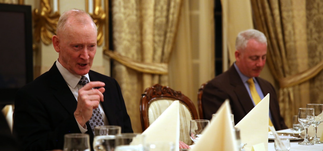 Lieutenant Gen. Richard Tryon (left), commander of U.S. Marine Corps Forces Command and U.S. Marine Corps Forces, Europe, talks with Romanian Maj. Gen. Nicolae-Ionel Ciuca’s staff during a Romanian-hosted dinner for Tryon and his staff in Bucharest, March 18, 2014. Tryon visited with Romanian military officials to discuss continuing the good military relationship between the United States and Romania. United States military forces are currently in Romania assigned to Mihail Kogalniceanu Air Base and the two nations work together during much of the Black Sea Rotational Force deployment. Black Sea Rotational Force 14 is a contingent of Marines and sailors tasked with maintaining positive relations with partner nations, regional stability and increasing interoperability while providing the capability for rapid crisis response, as directed by U.S. European Command, in the Black Sea, Balkan and Caucasus regions of Eastern Europe. (Official Marine Corps photo by Lance Cpl. Scott W. Whiting, BSRF PAO/ Released)