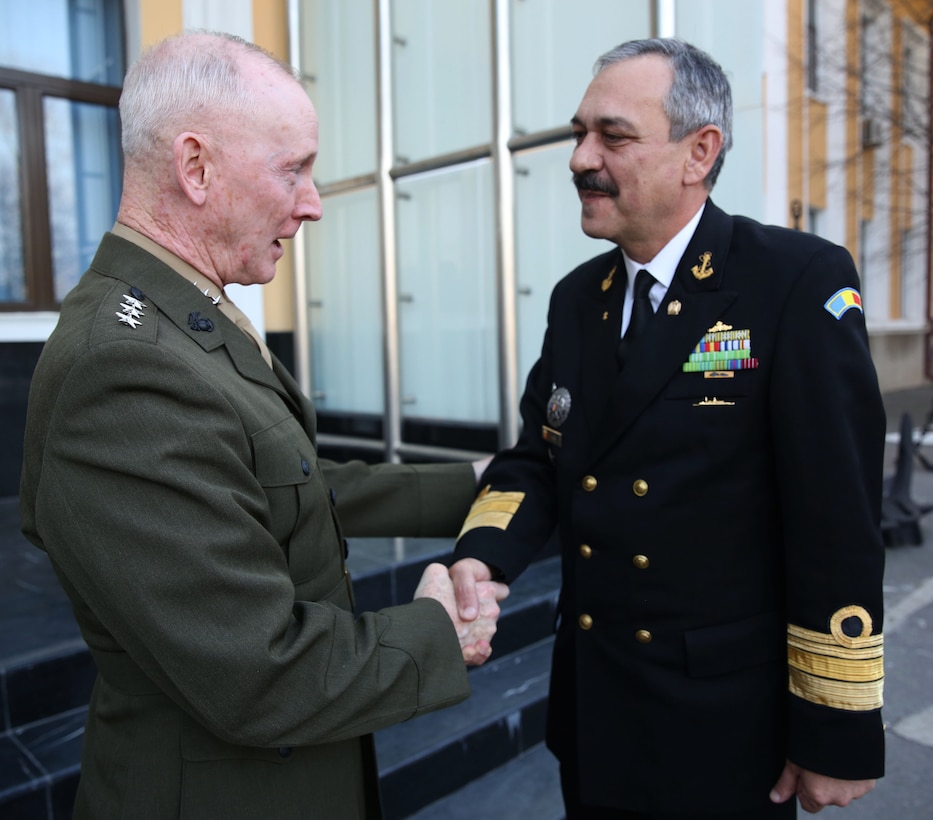 Lieutenant Gen. Richard Tryon, commander of U.S. Marine Corps Forces Command and U.S. Marine Corps Forces, Europe, shakes hands with Romanian Rear Admiral Alexandru Mirsu, chief of Romanian naval forces, after meeting with him and his staff in Bucharest, March 18, 2014. Tryon visited with Romanian military officials to discuss continuing the good military relationship between the United States and Romania. United States military forces are currently in Romania assigned to Mihail Kogalniceanu Air Base and the two nations work together during much of the Black Sea Rotational Force deployment. Black Sea Rotational Force 14 is a contingent of Marines and sailors tasked with maintaining positive relations with partner nations, regional stability and increasing interoperability while providing the capability for rapid crisis response, as directed by U.S. European Command, in the Black Sea, Balkan and Caucasus regions of Eastern Europe. (Official Marine Corps photo by Lance Cpl. Scott W. Whiting, BSRF PAO/ Released)