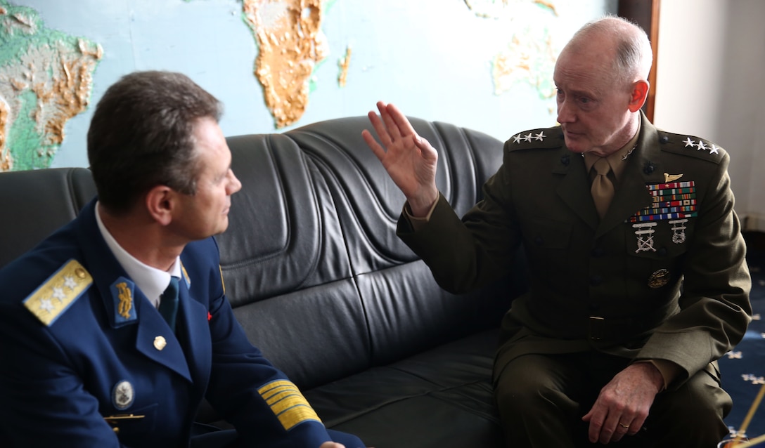 United State Marine Corps Lt. Gen. Richard Tryon, commander of U.S. Marine Corps Forces Command and U.S. Marine Corps Forces, Europe, speaks privately with Romanian Lt. Gen. Stefan Danila, Chief of Romanian general staff, before their official meeting March 18, 2014, in Bucharest. Tryon visited with Romanian military officials to discuss continuing the good military relationship between the United States and Romania. United States military forces are currently in Romania assigned to Mihail Kogalniceanu Air Base and the two nations work together during much of the Black Sea Rotational Force deployment. Black Sea Rotational Force 14 is a contingent of Marines and sailors tasked with maintaining positive relations with partner nations, regional stability and increasing interoperability while providing the capability for rapid crisis response, as directed by U.S. European Command, in the Black Sea, Balkan and Caucasus regions of Eastern Europe. (Official Marine Corps photo by Lance Cpl. Scott W. Whiting, BSRF PAO/ Released)