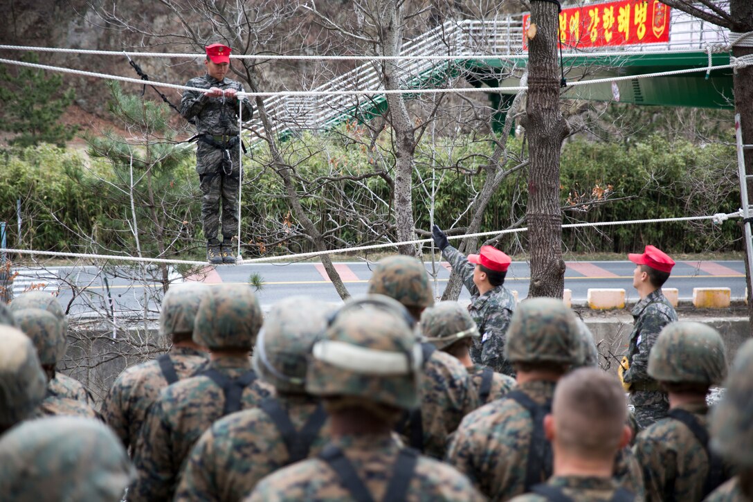 Republic of Korea Marines instruct U.S. Marines on how to properly cross a rope bridge March 19 during the second day of the three-day Mountain Warfare Training Course at the Mountain Warfare Training Center in Pohang, Republic of Korea. A rope bridge can be made of one, two or sometimes three ropes to enable the traveler to cross rivers or ravines. The U.S. Marines going through the course are with various units under III Marine Expeditionary Force Headquarters Group and are in the Republic of Korea to take part in Marine Expeditionary Force Exercise 2014. MEFEX 14 exercises the interoperability and combined capabilities of the ROK and U.S. Marine Corps. (U.S. Marine Corps photo by Lance Cpl. Cedric R. Haller II/RELEASED)